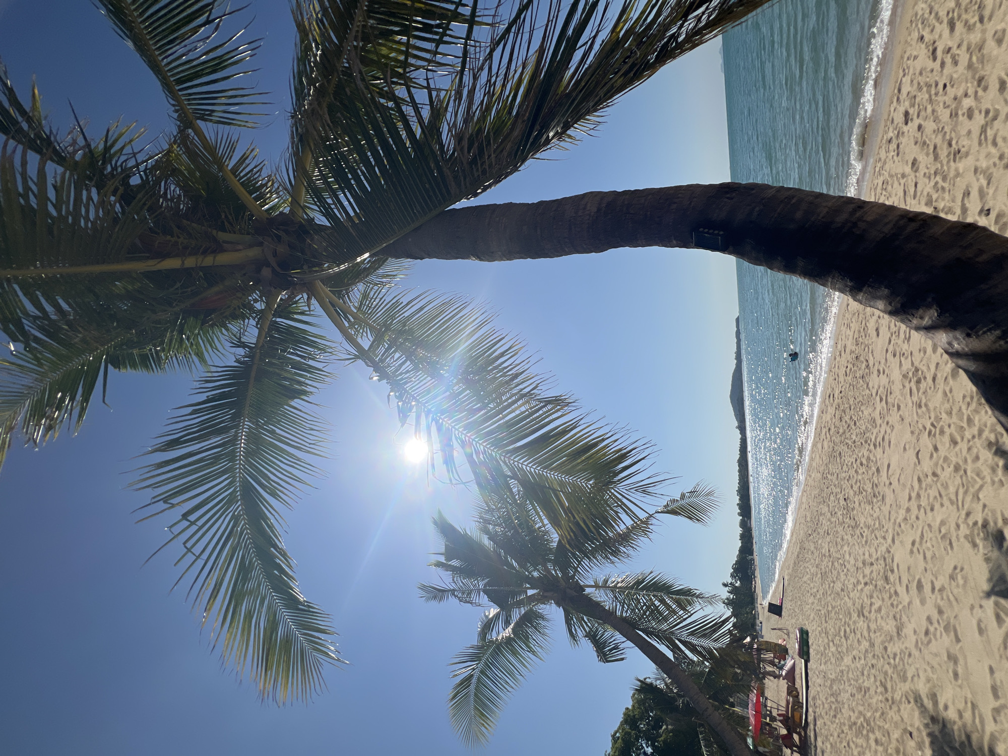 Ko Samui beach morning: jet skis, palm trees, and shoreside activity