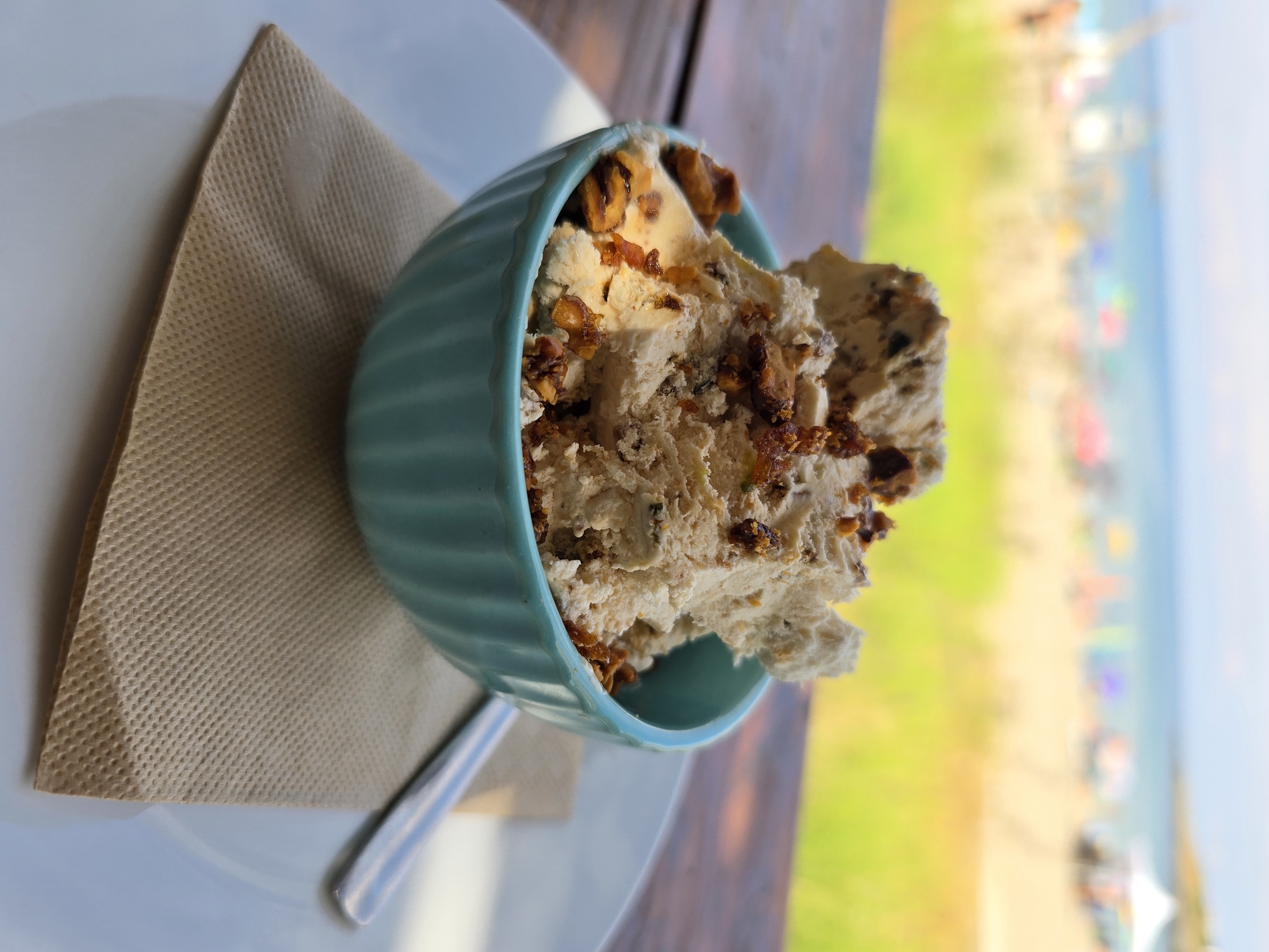 Ice cream bowl with nuts and crunchy toppings, close-up