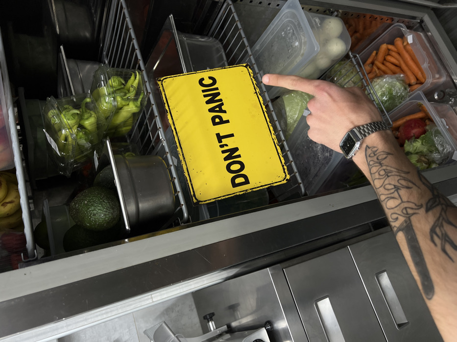 Kitchen worker documents food prep activities in Budva