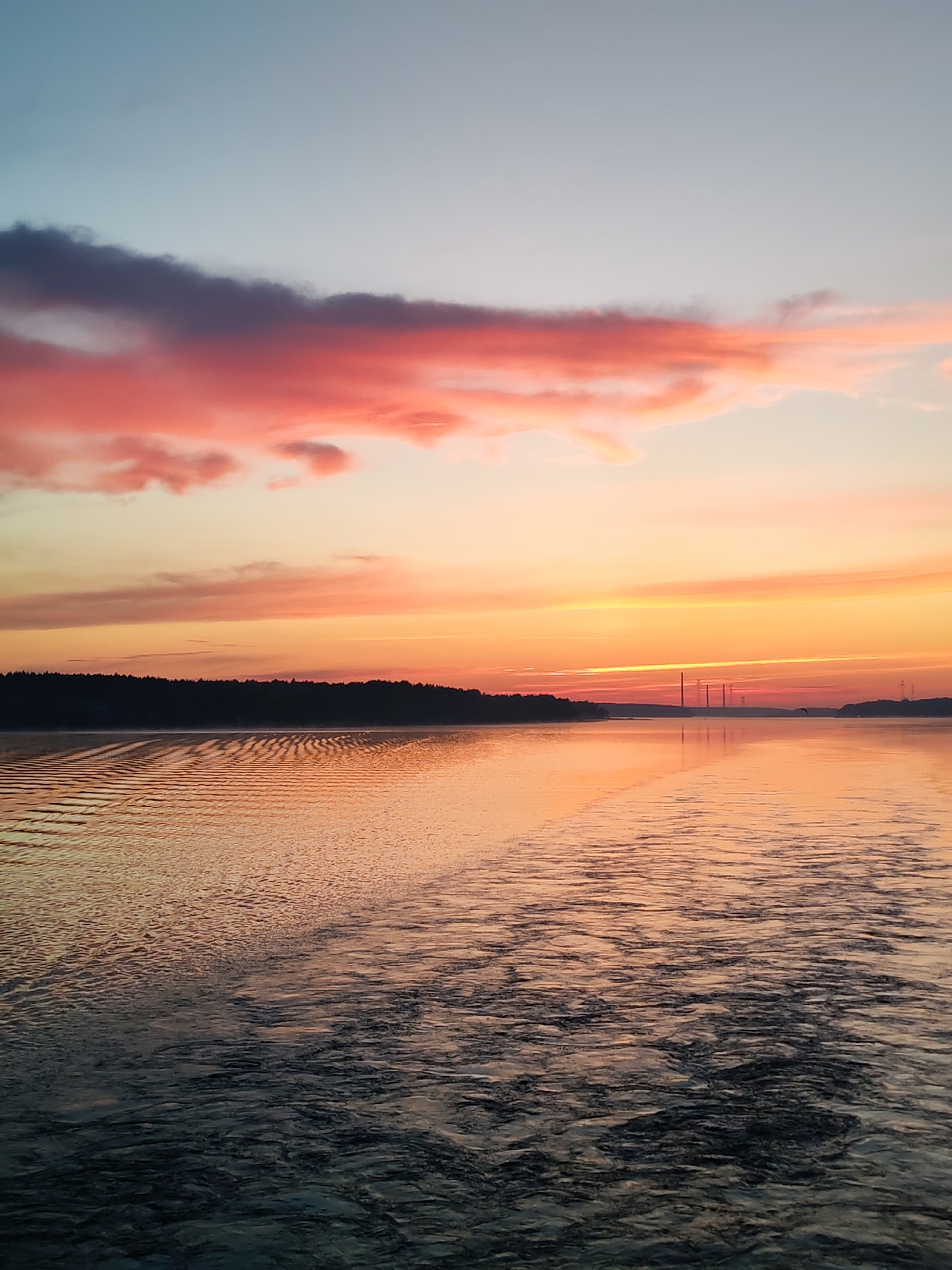Colorful sunset witnessed over water near Плоски, Russia