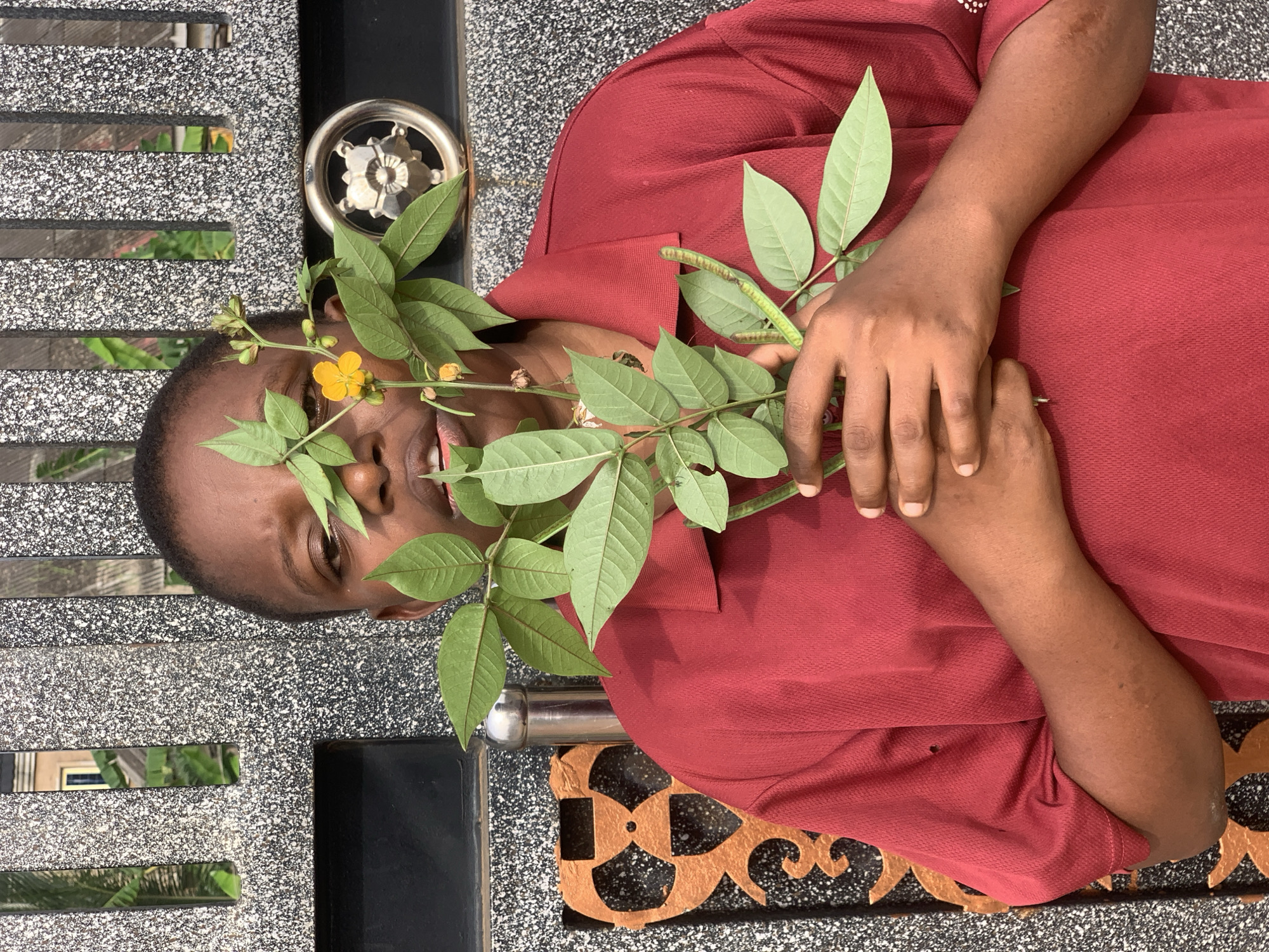 Person photographed in multiple poses with flowers in Ikorodu