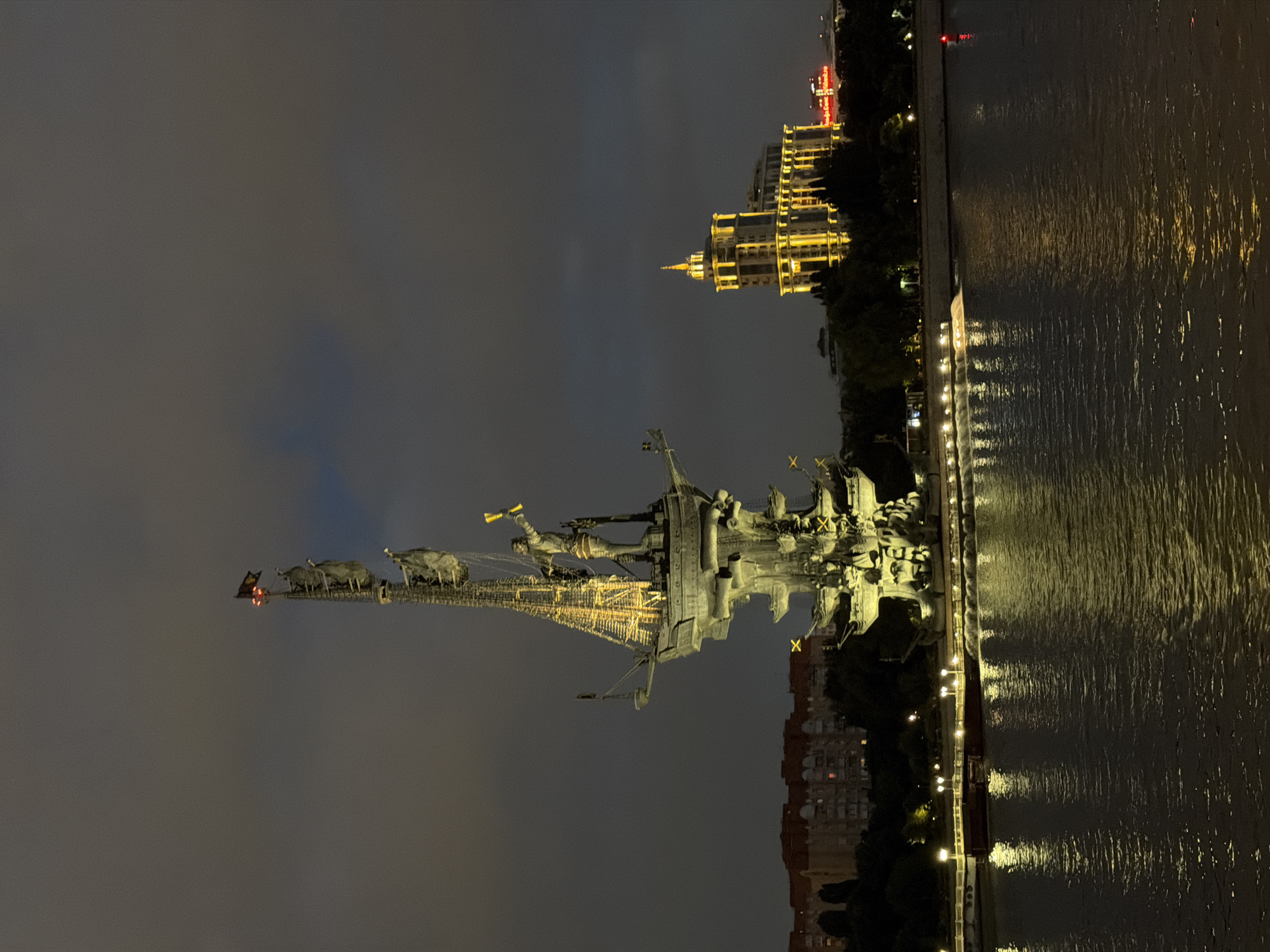 Peter the Great Statue glowing over the Moscow River at night