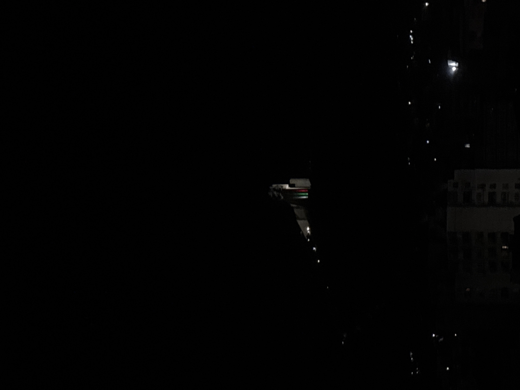 Witness documents nighttime urban residential area with illuminated buildings