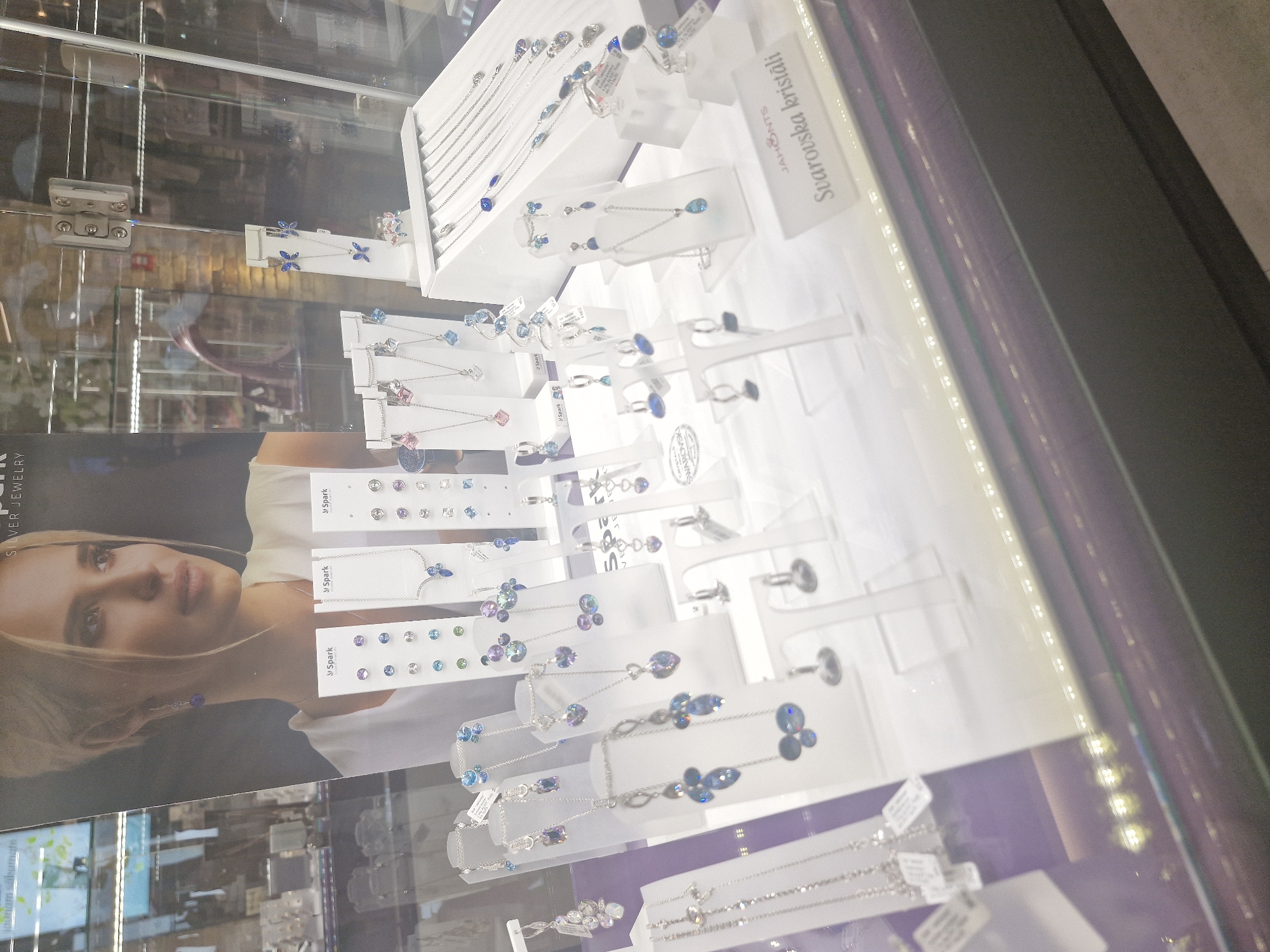 Shopper documents jewelry displays and clothing stores during mall visit