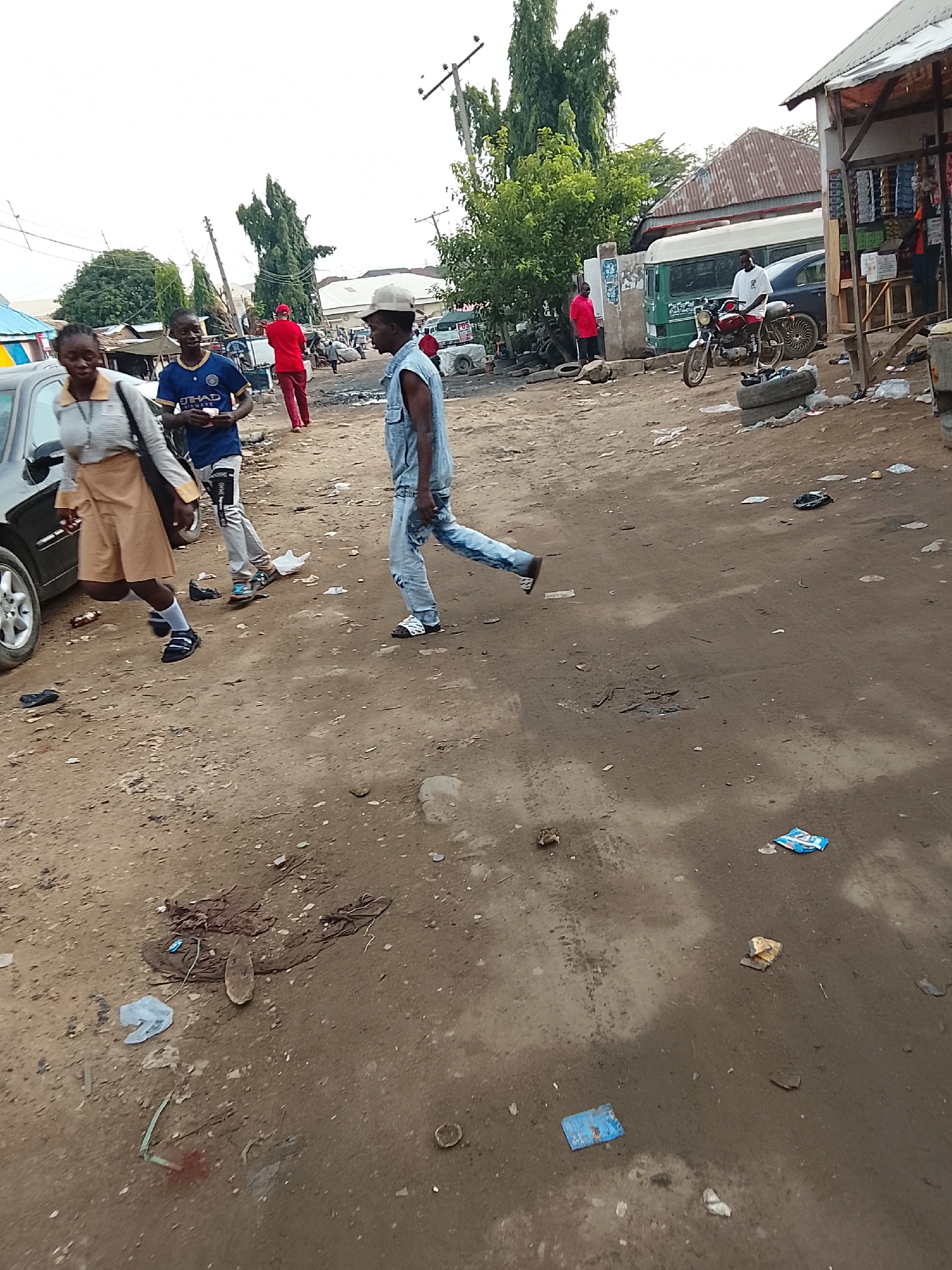 Morning street life documented on Abuja dirt road