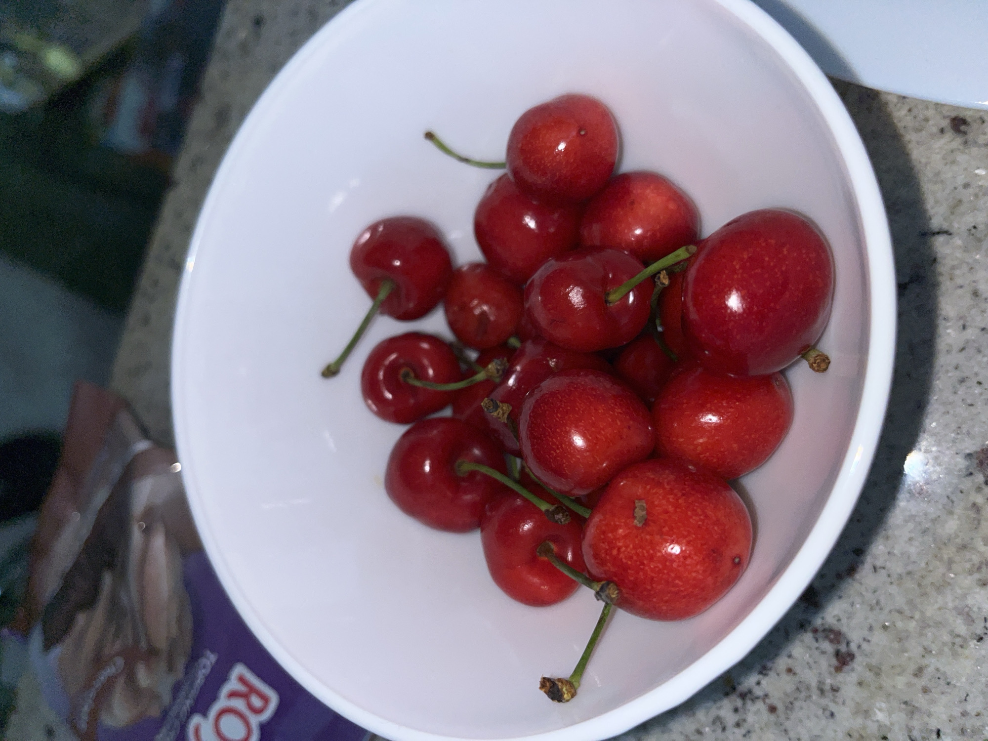 Young man enjoys bowl of fresh cherries in Zlatograd