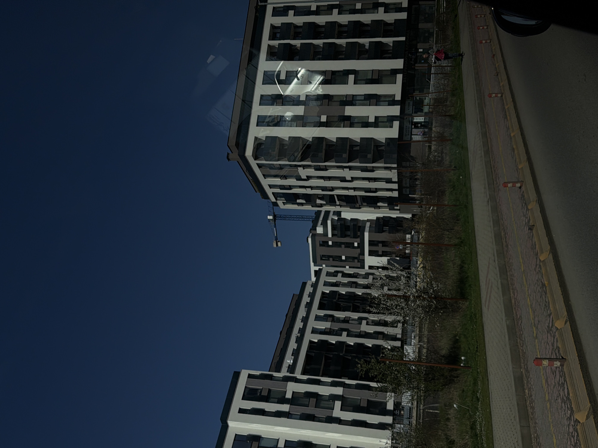 Modern apartment building photographed in Sofia, construction crane nearby