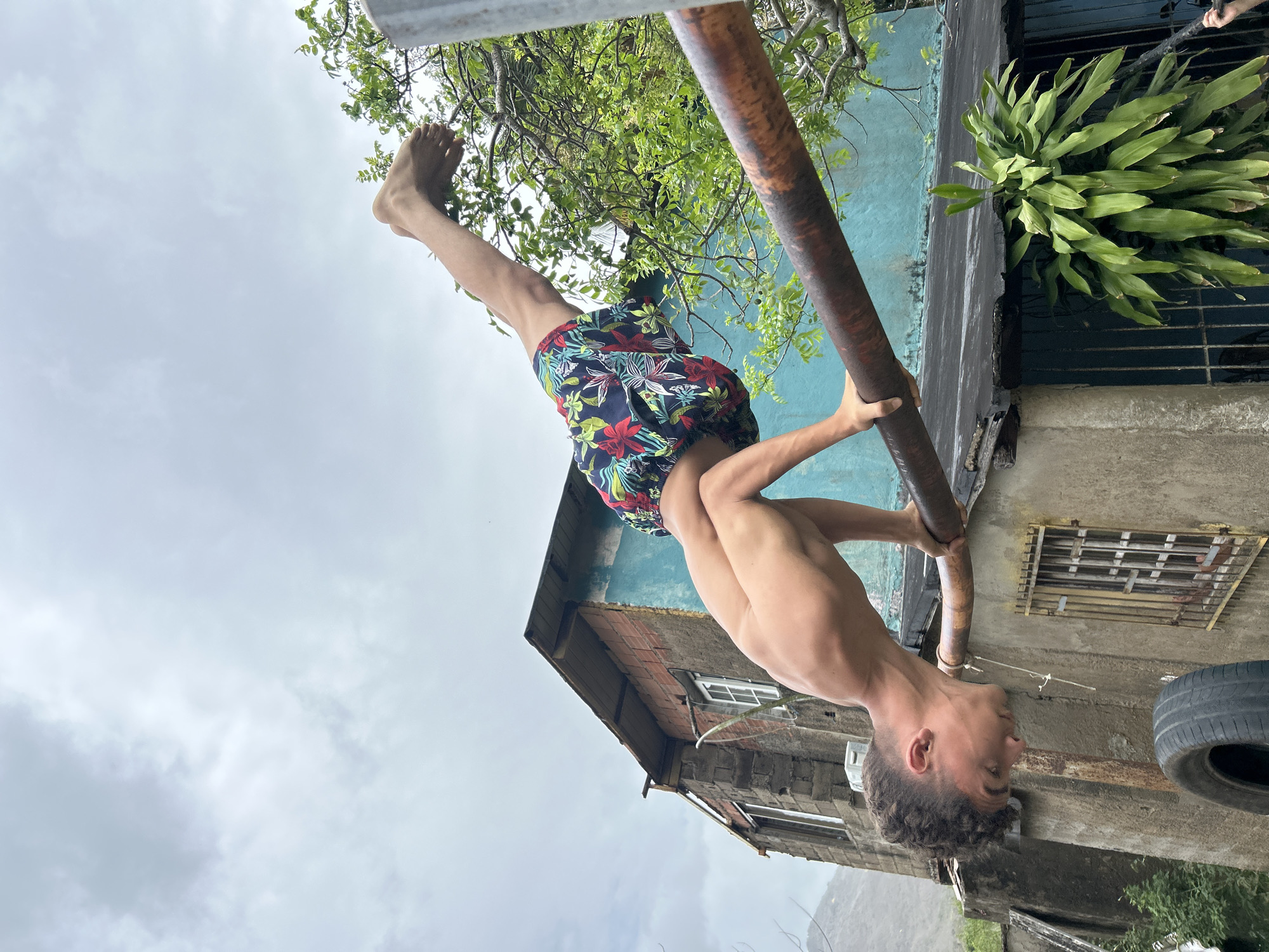 Young man climbs mango trees, exercises outdoors in Venezuelan community