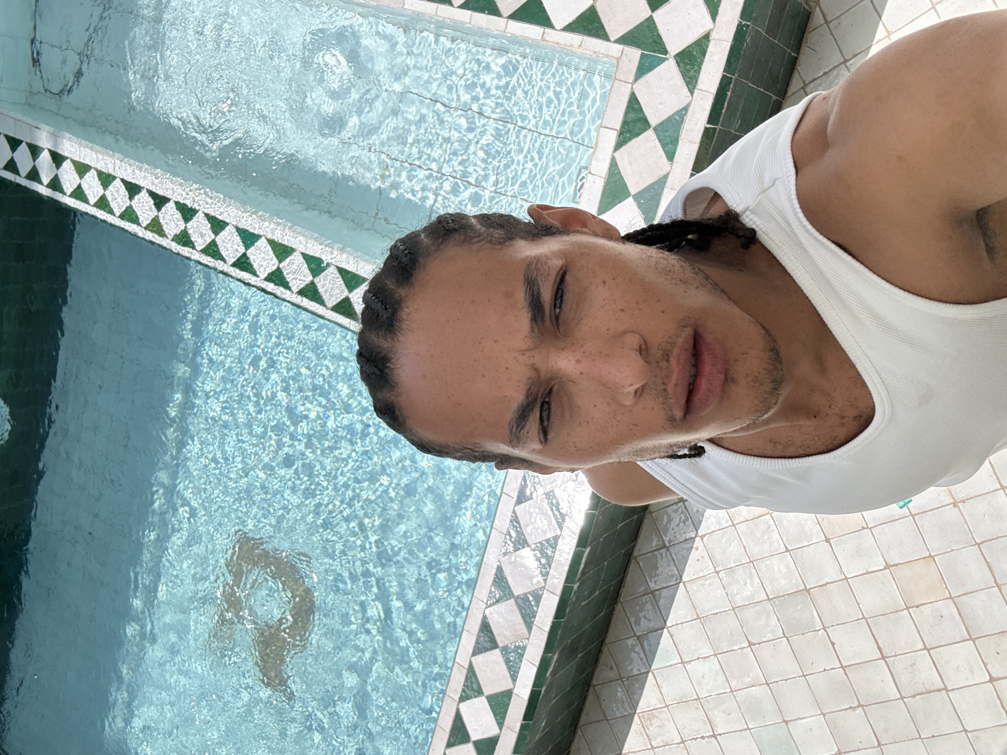 Man poses poolside at Morocco's Mechouar Kasbah