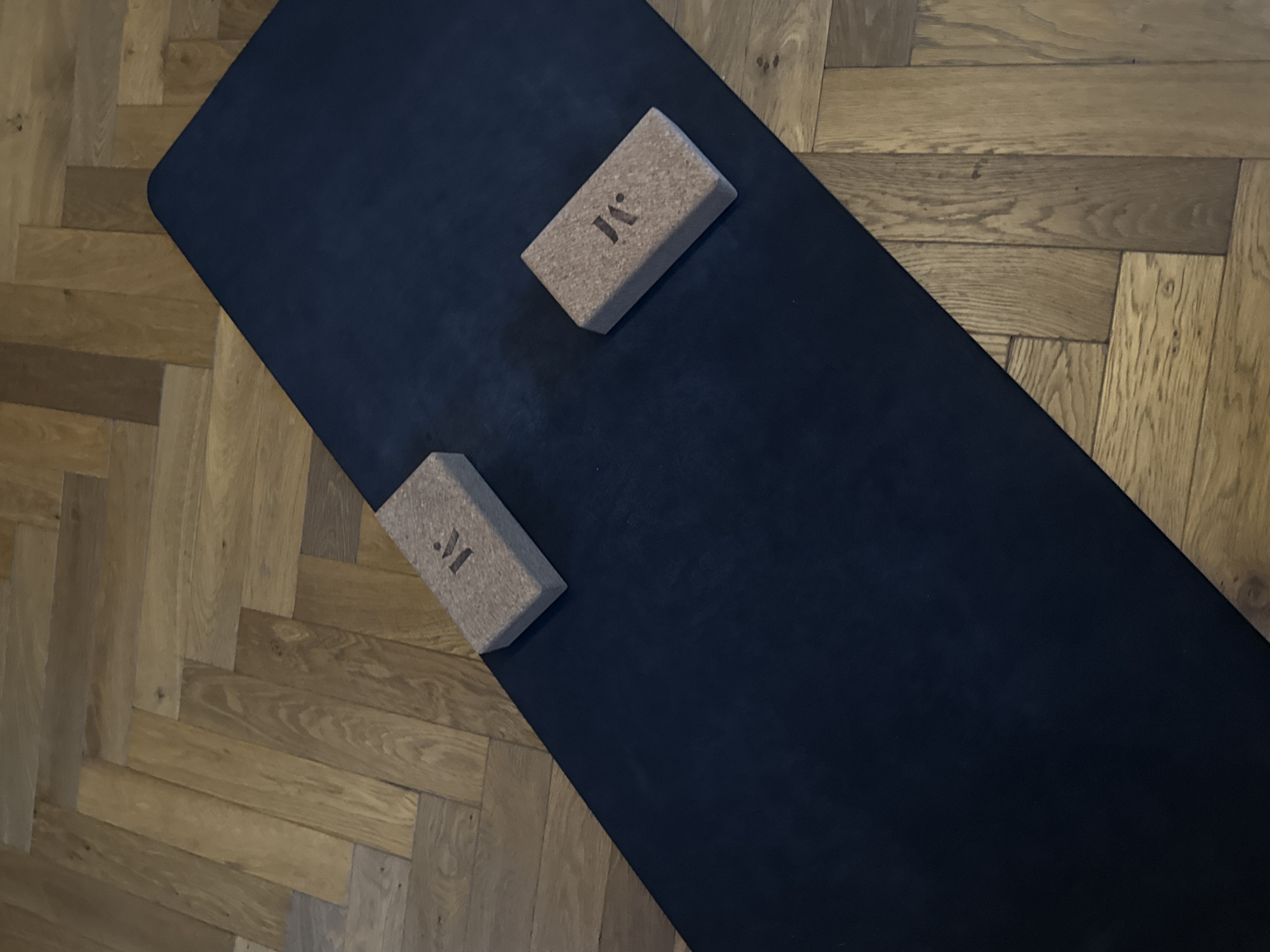 Yoga equipment with branded blocks photographed on London floor