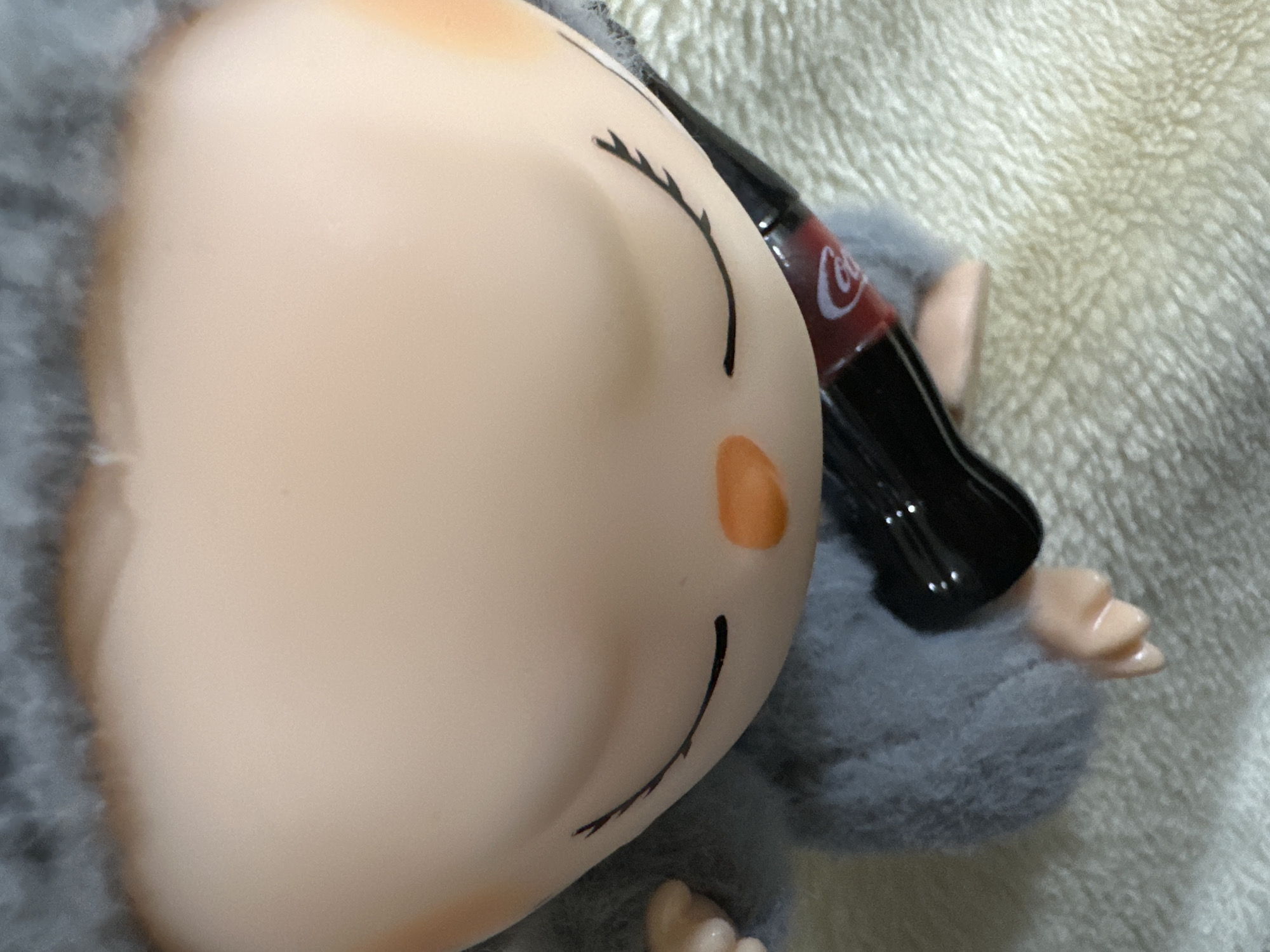 Fuzzy toy and AirPods case examined close-up in Samshvilde