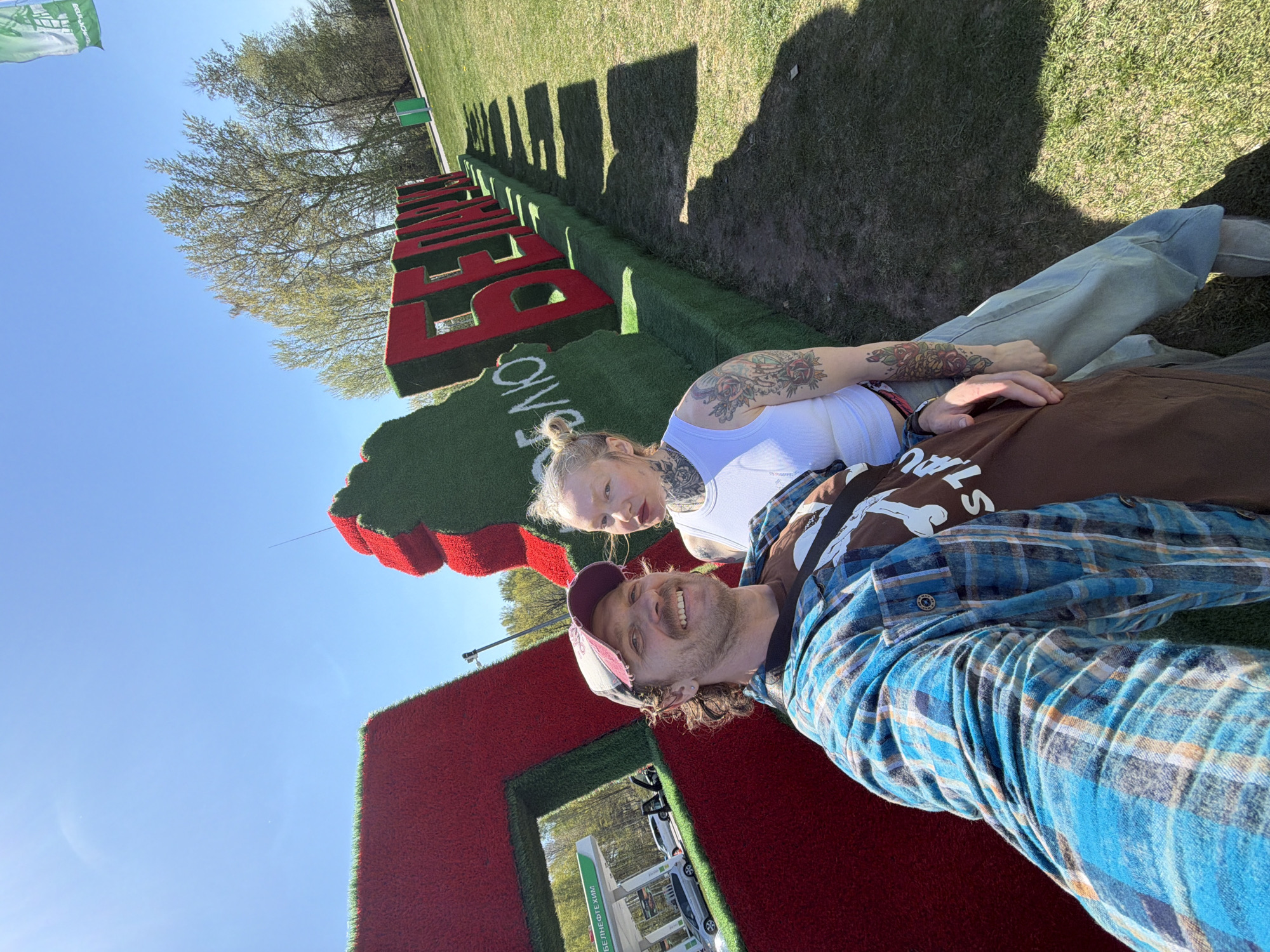 Visitors pose at Belarus topiary installation spelling love message