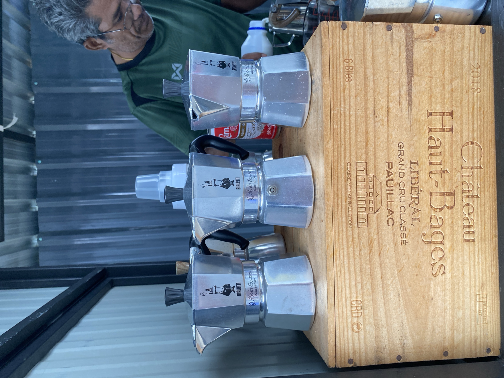 Coffee vendor serves customers during rainy morning in Thailand