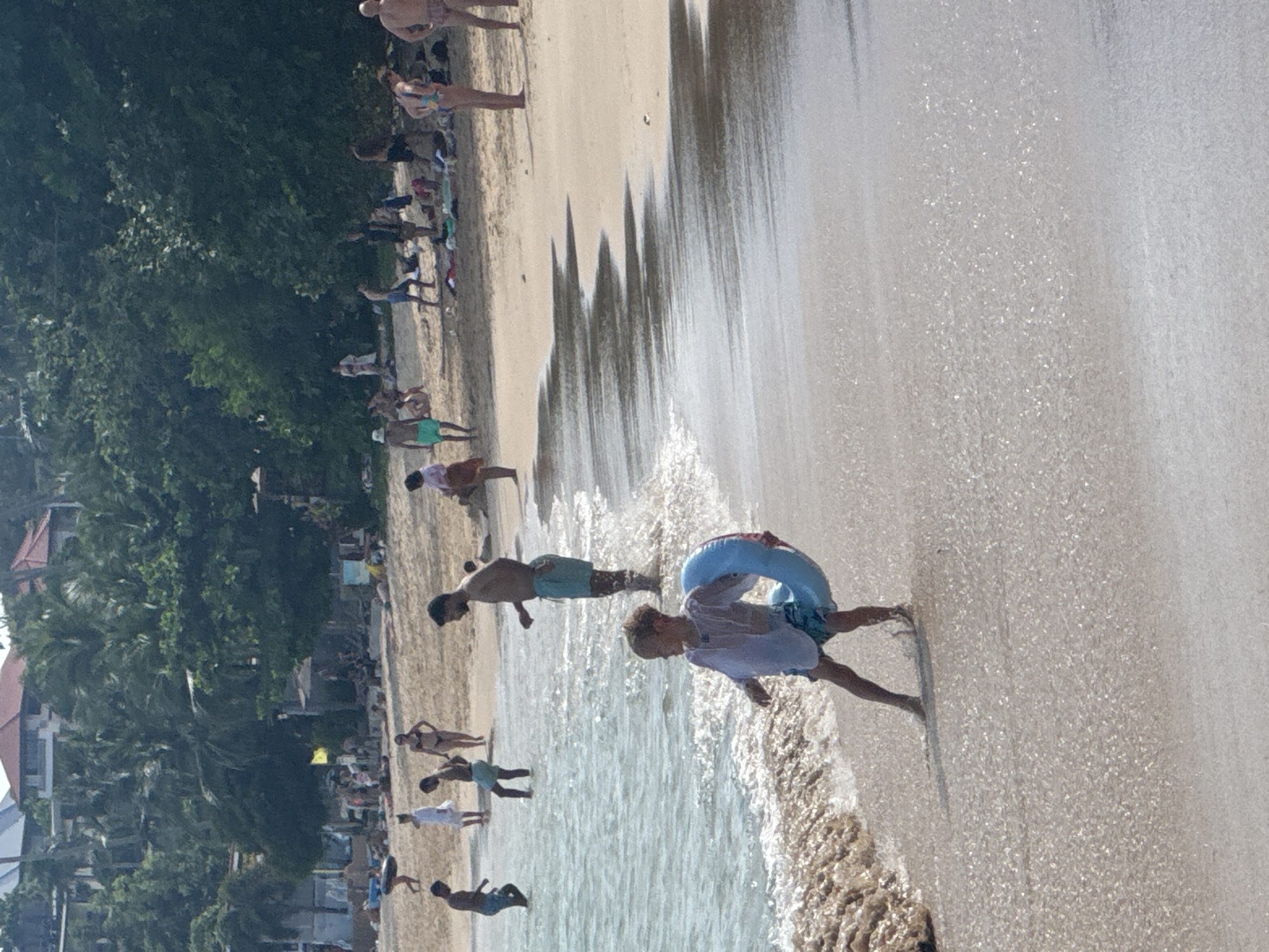 Beach day in Wichit: paddleboarding, floats, and shoreline scenes
