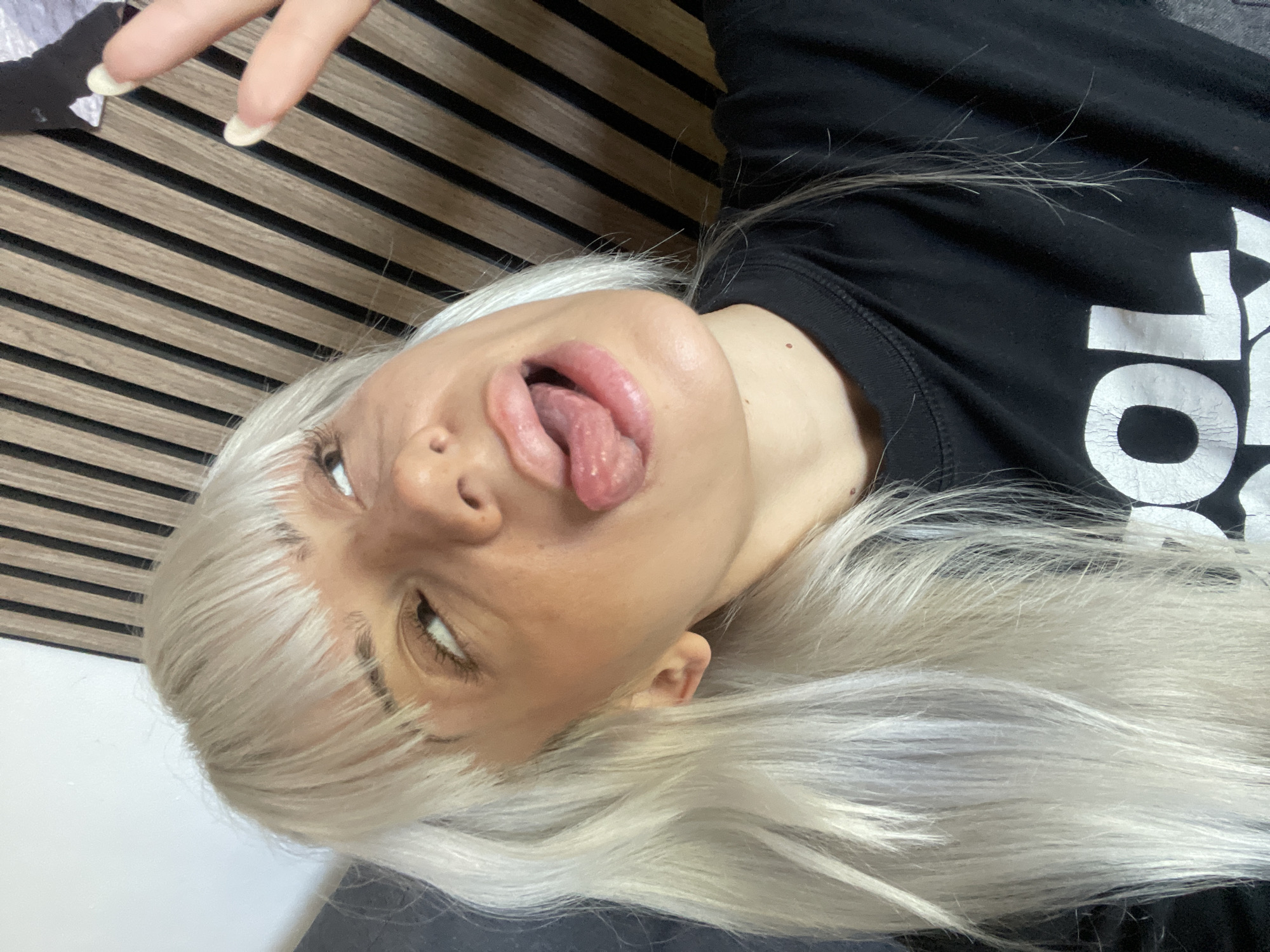Woman photographed lying down, tongue out in Tilburg