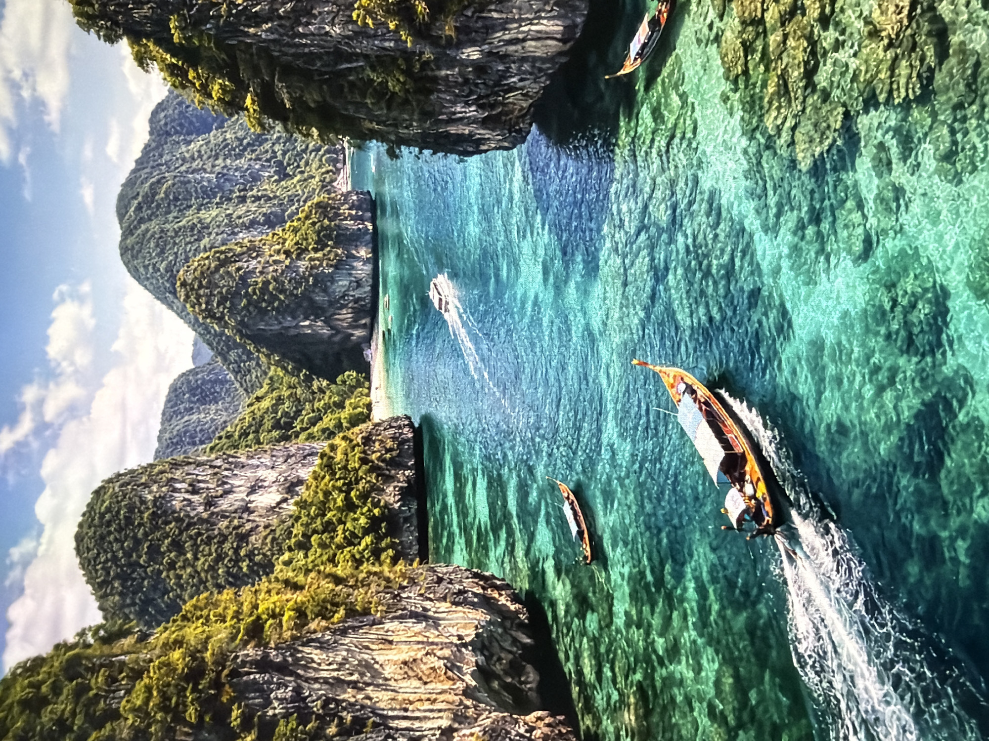 Tropical bay with limestone karsts and longtail boats documented
