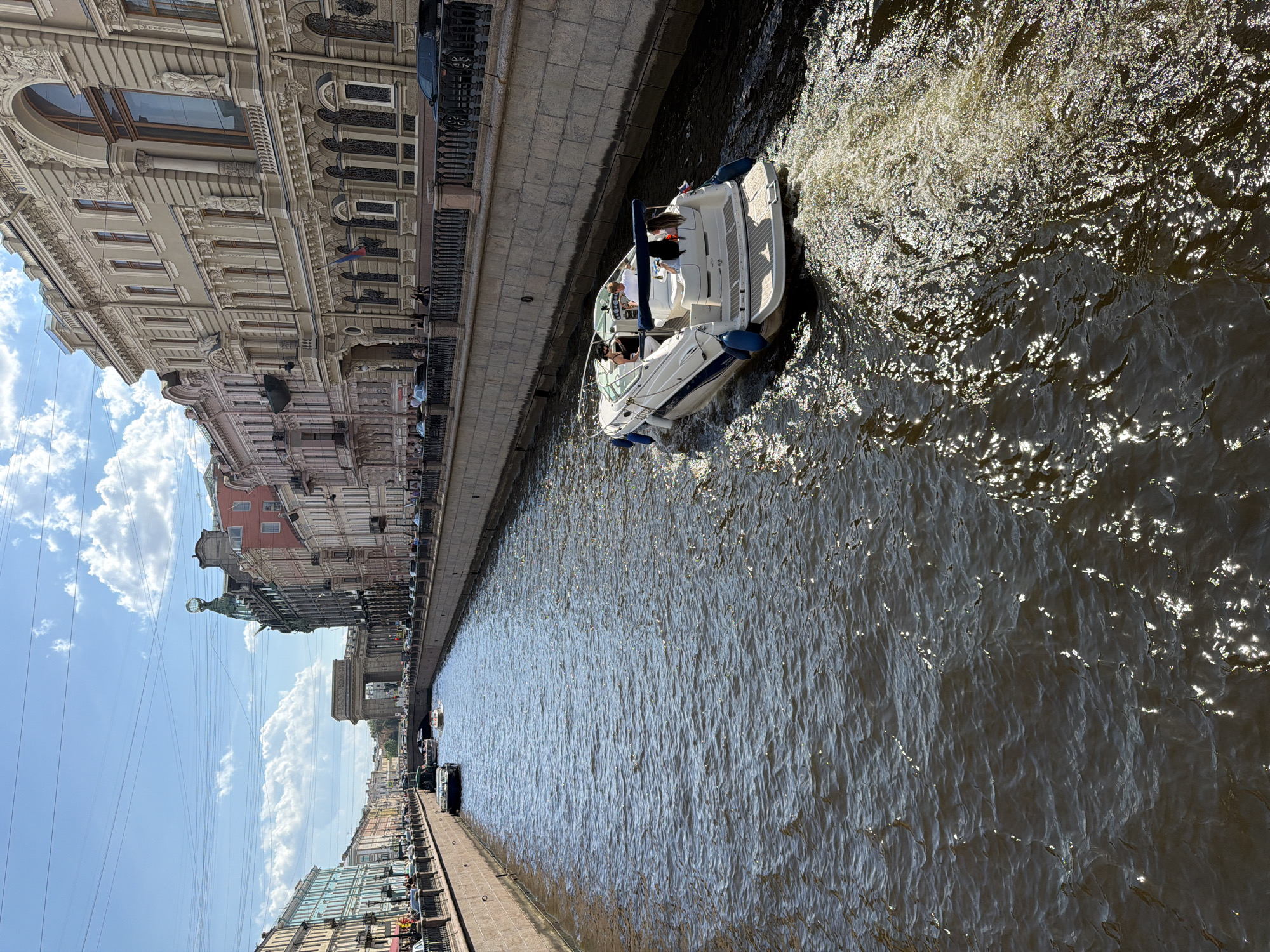 Tourist documents sunny canal cruise in Saint Petersburg