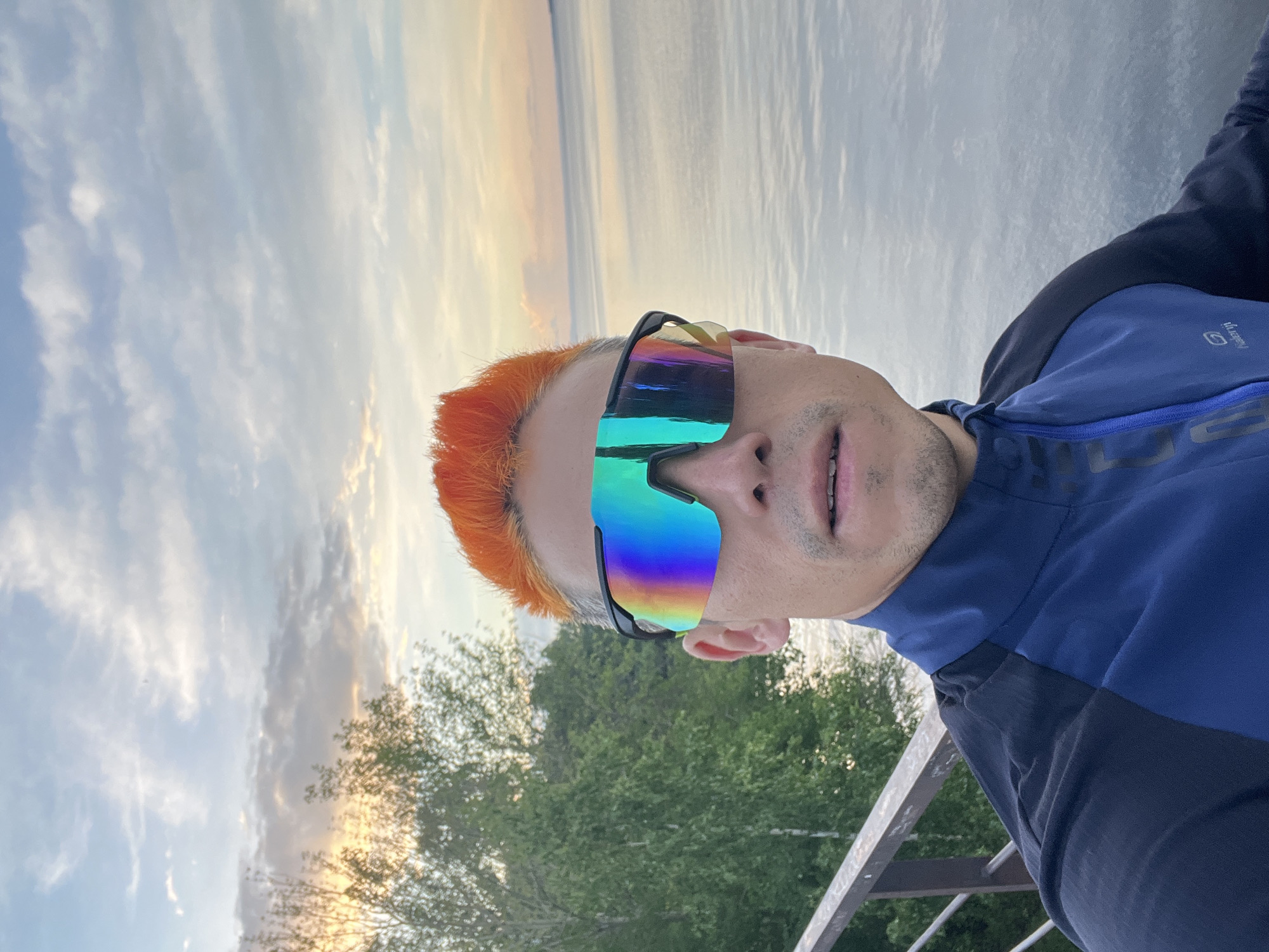 Orange-haired man takes selfies, jumps by waterfront in Chaikovsky