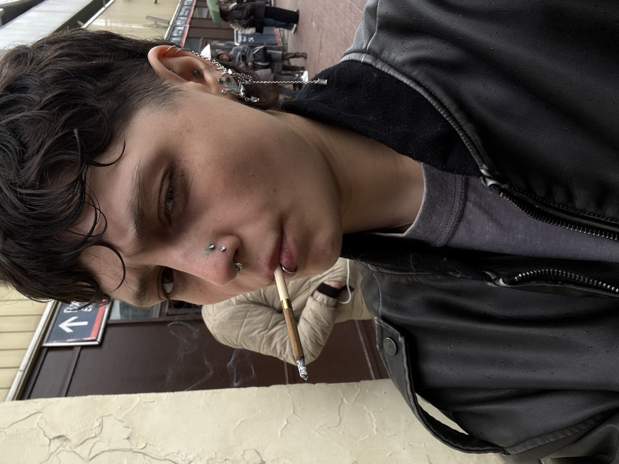 Person films self smoking at busy train station