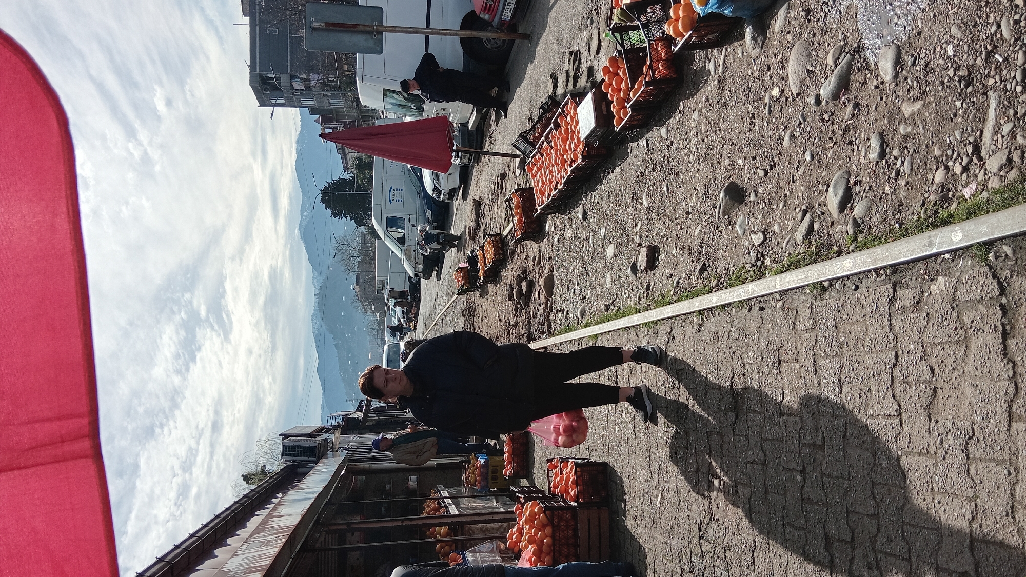 Woman walks through street market in Batumi, Georgia