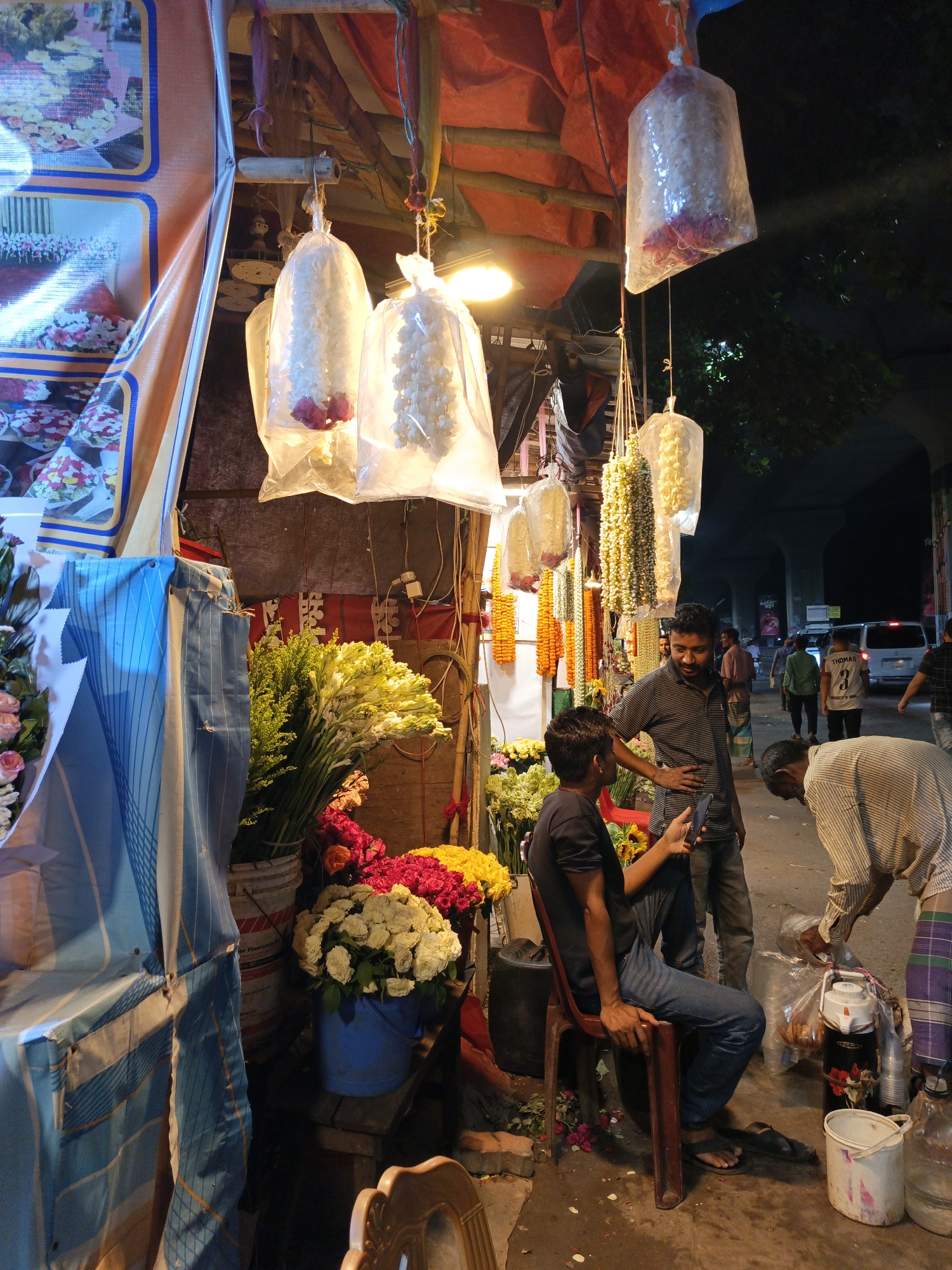 Evening flower market bustles along Dhaka street