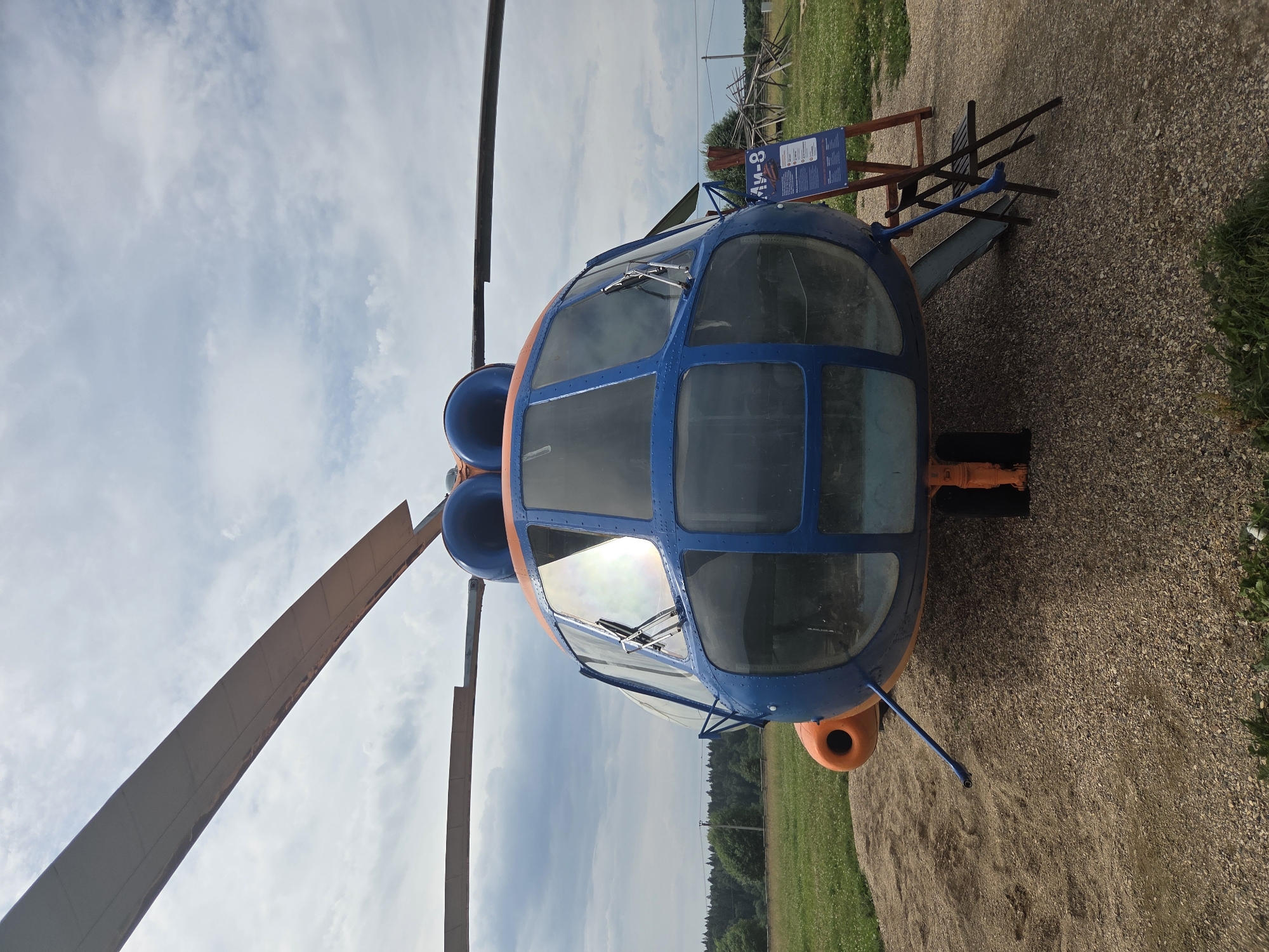 Mi-8 helicopter parked on gravel outside Bukharovo