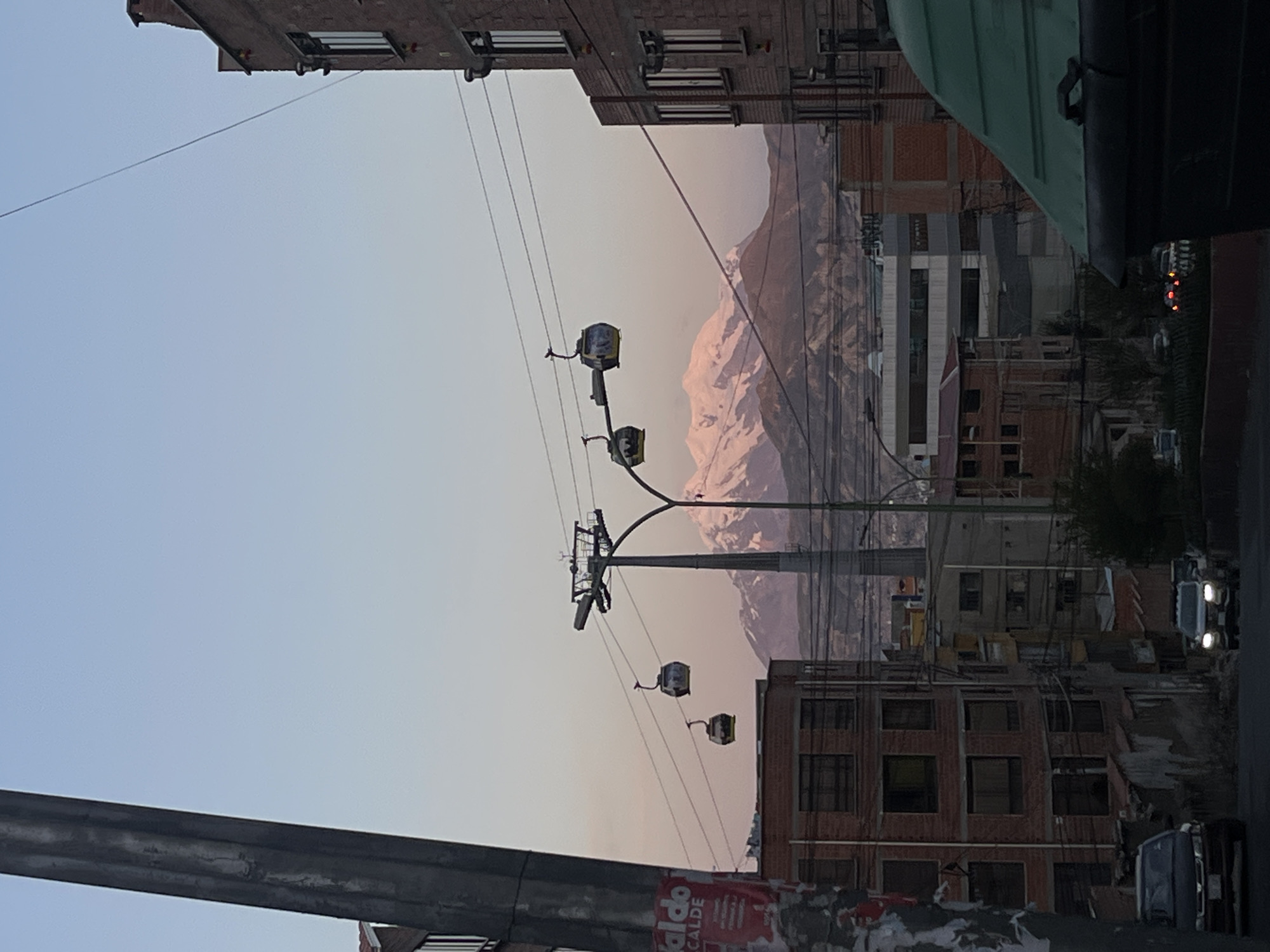 Cable cars operate above La Paz cityscape with mountains