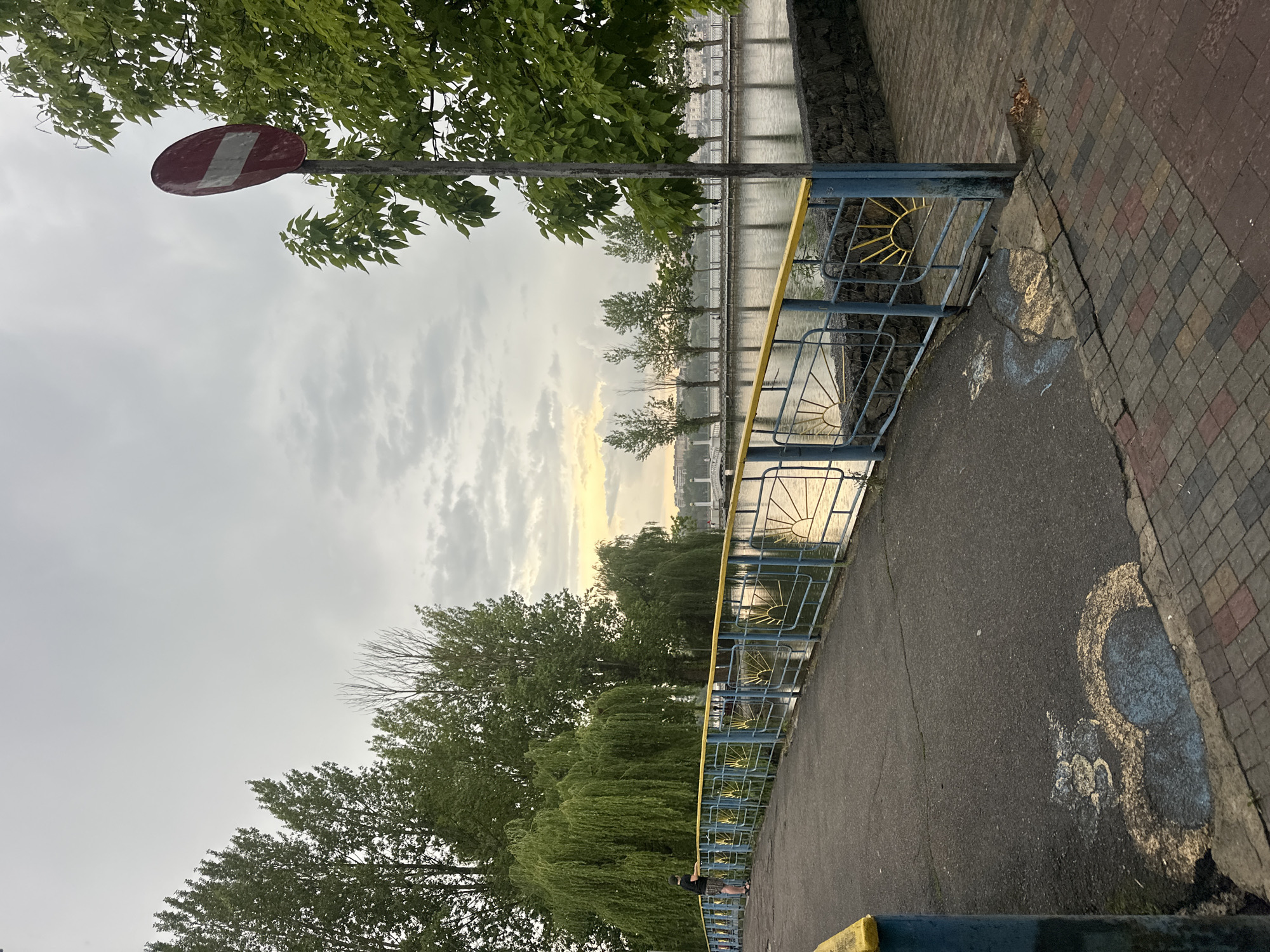 A cloudy afternoon along Ternopil Pond's promenade and waterfront