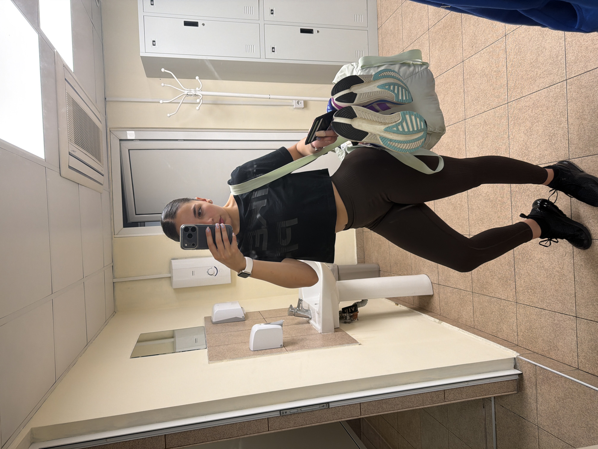 Woman takes multiple selfies in Gabrovo restroom facility