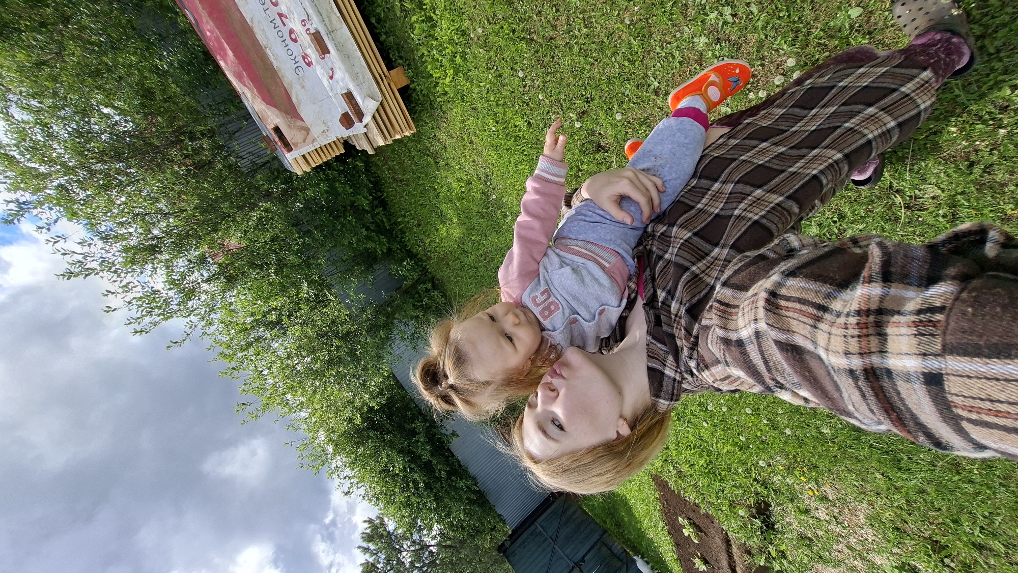 Woman and child enjoy spring morning in Russian village