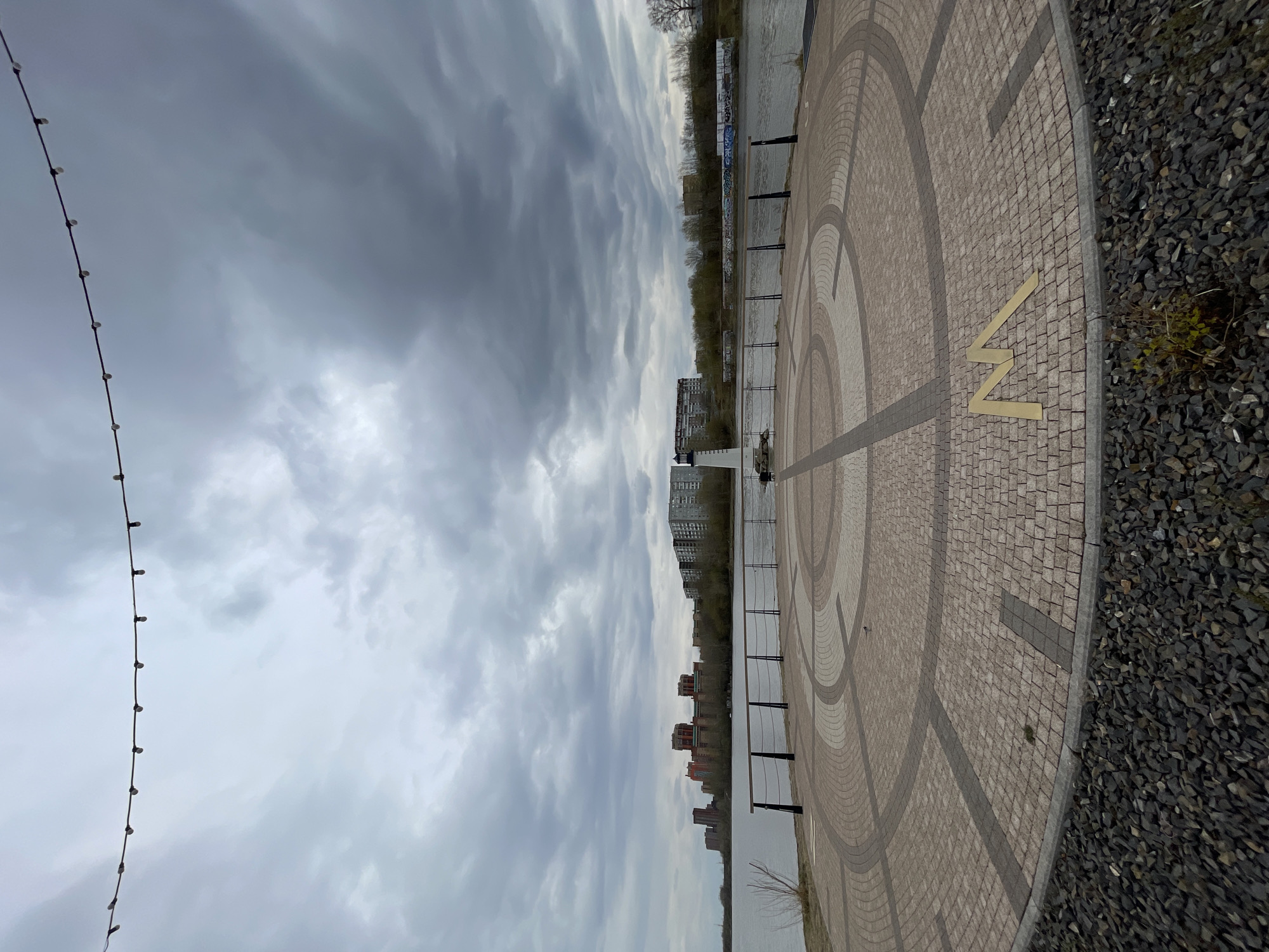 Yenisey River embankment with brass 'N' symbol documented in Krasnoyarsk