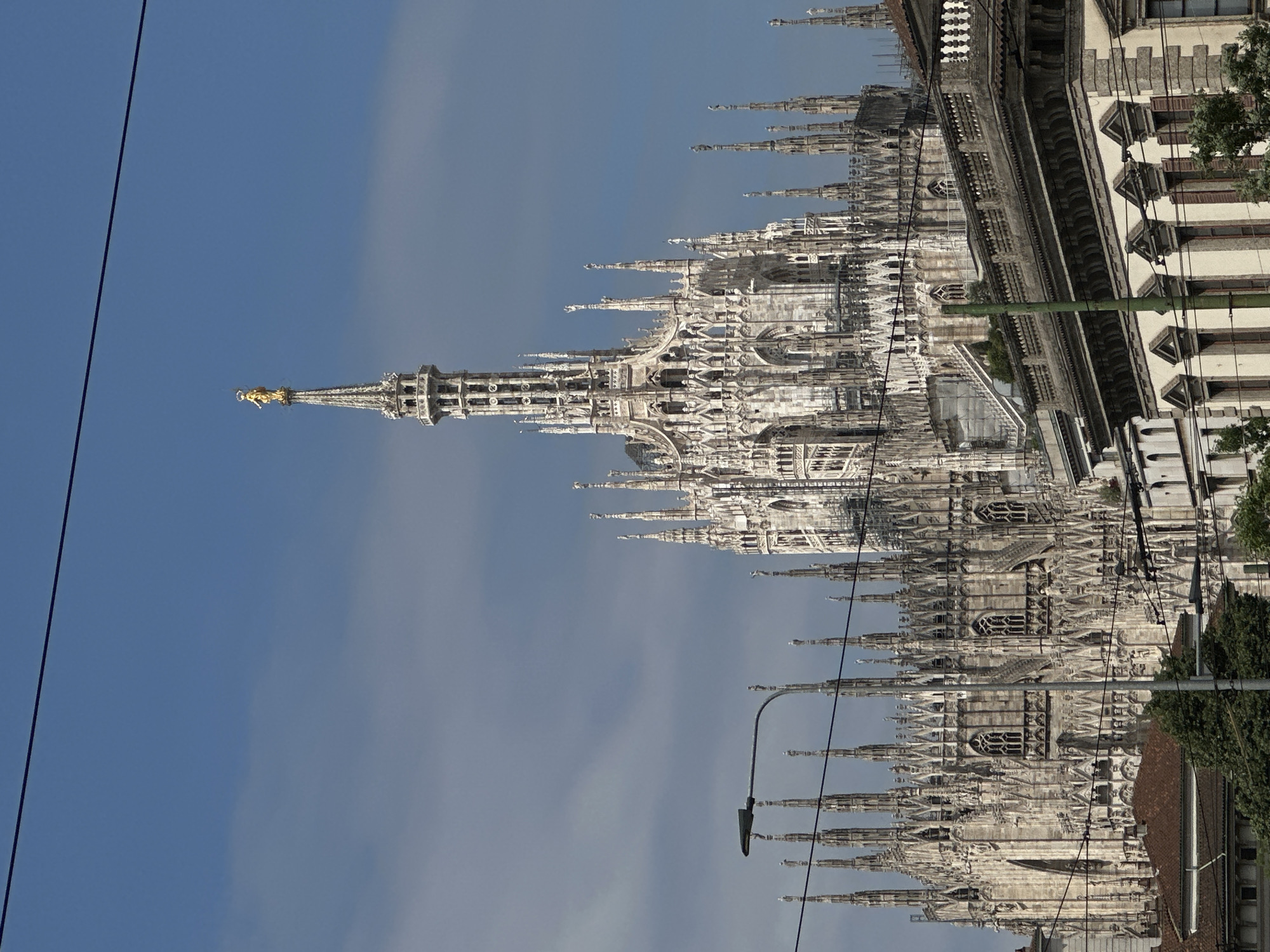 Tourist documents Milan Cathedral and historic architecture during morning walk