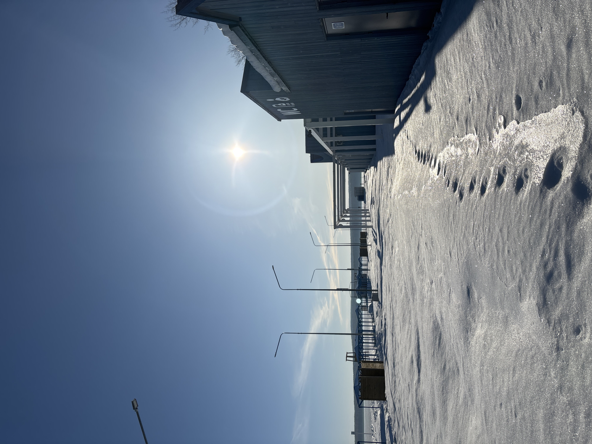 Snow-covered pier observed on sunny day in Chaikovsky, Russia