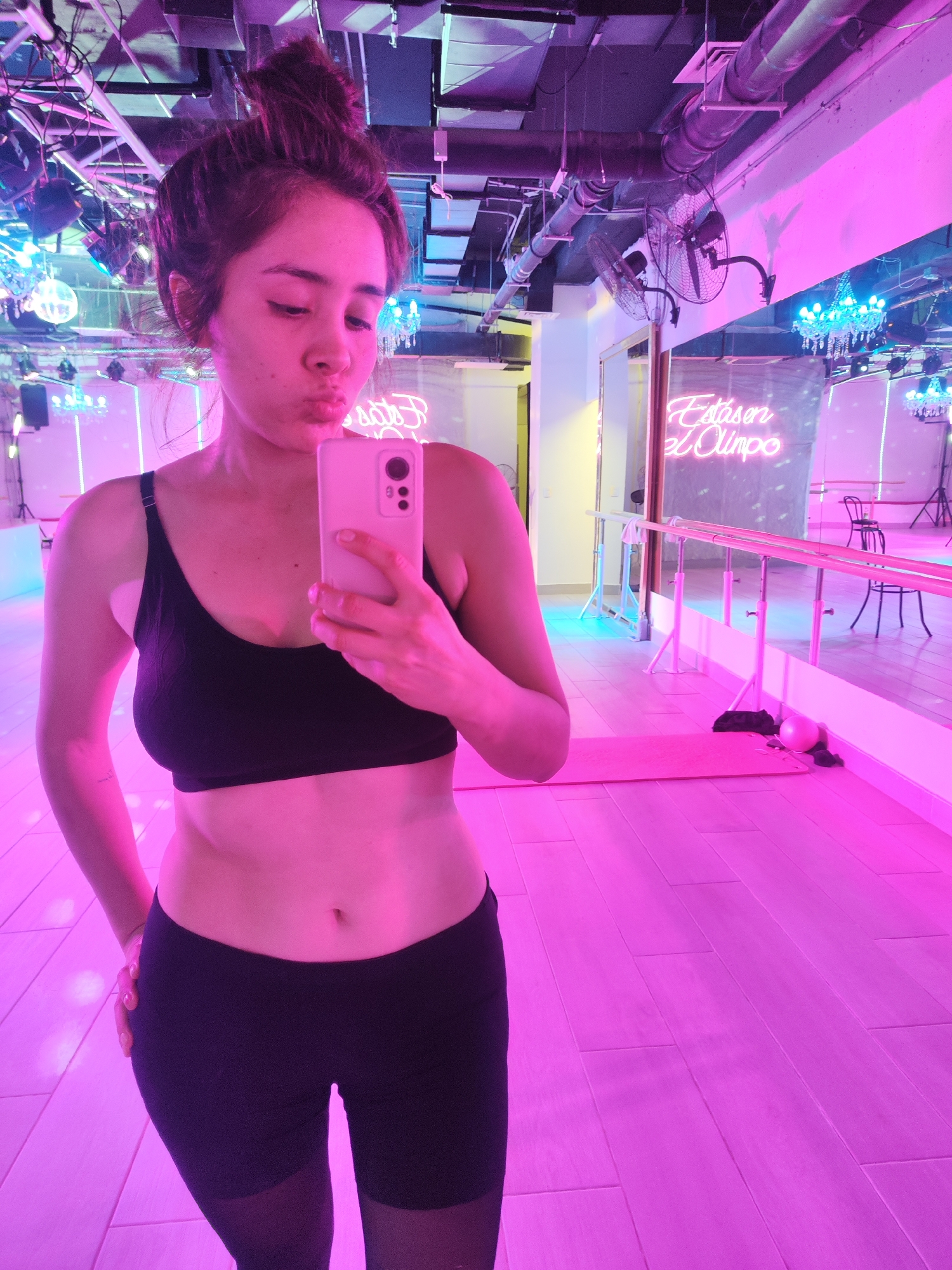 Mirror selfie in a pink-lit Santiago dance studio