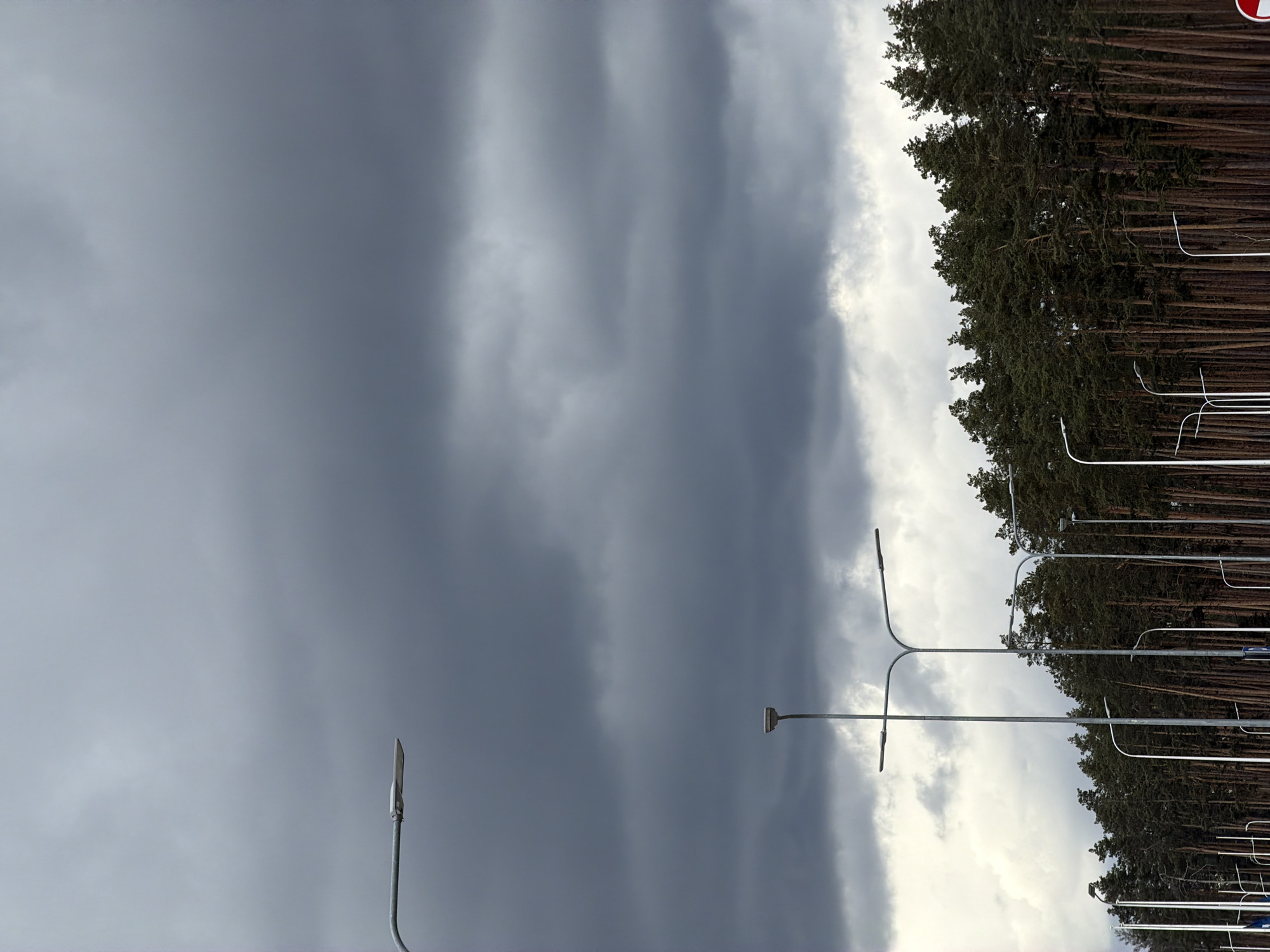 Dark clouds gather over Ulbroka, Latvia treeline