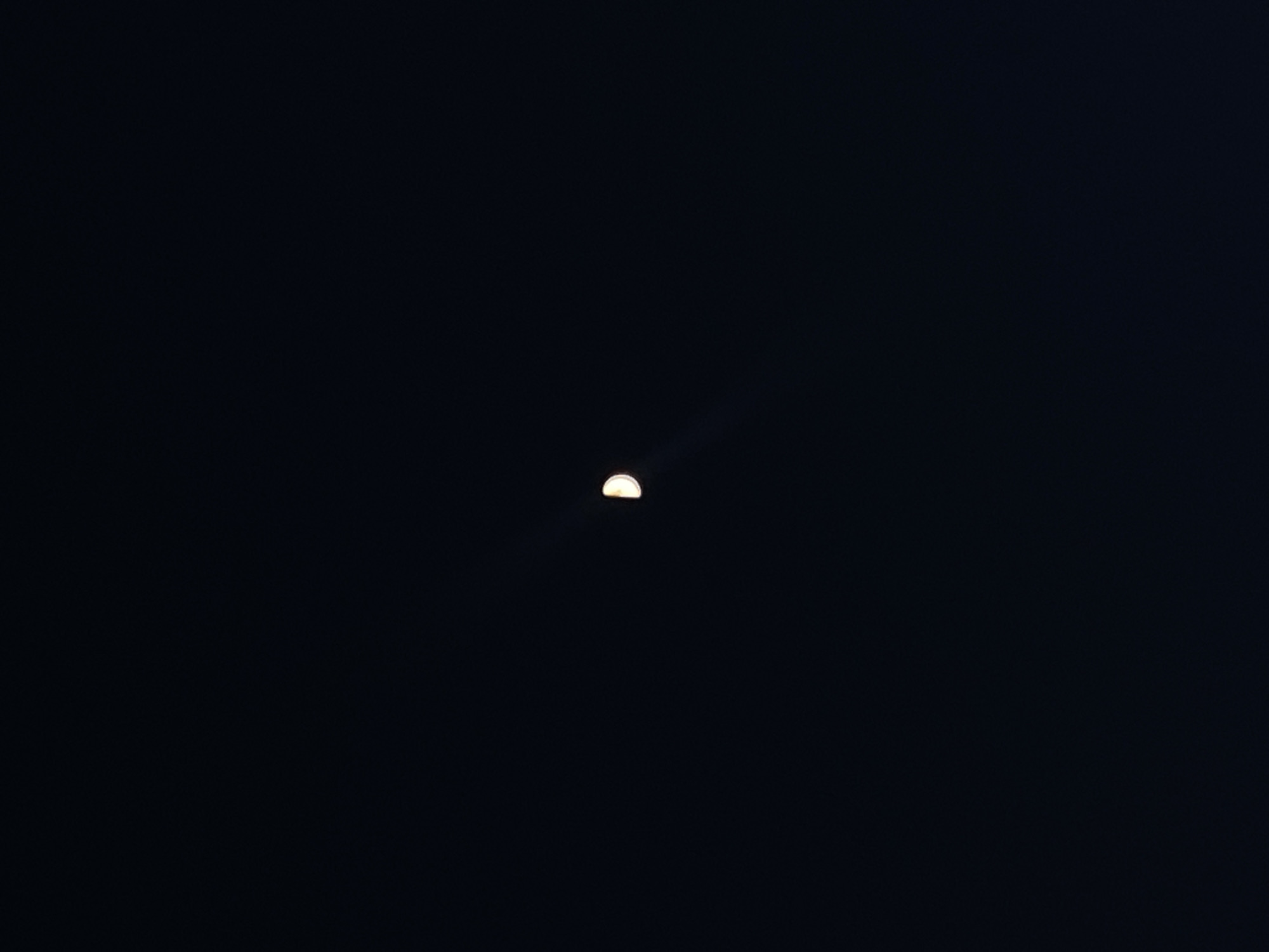Crescent moon photographed in night sky over Шебунино, Russia