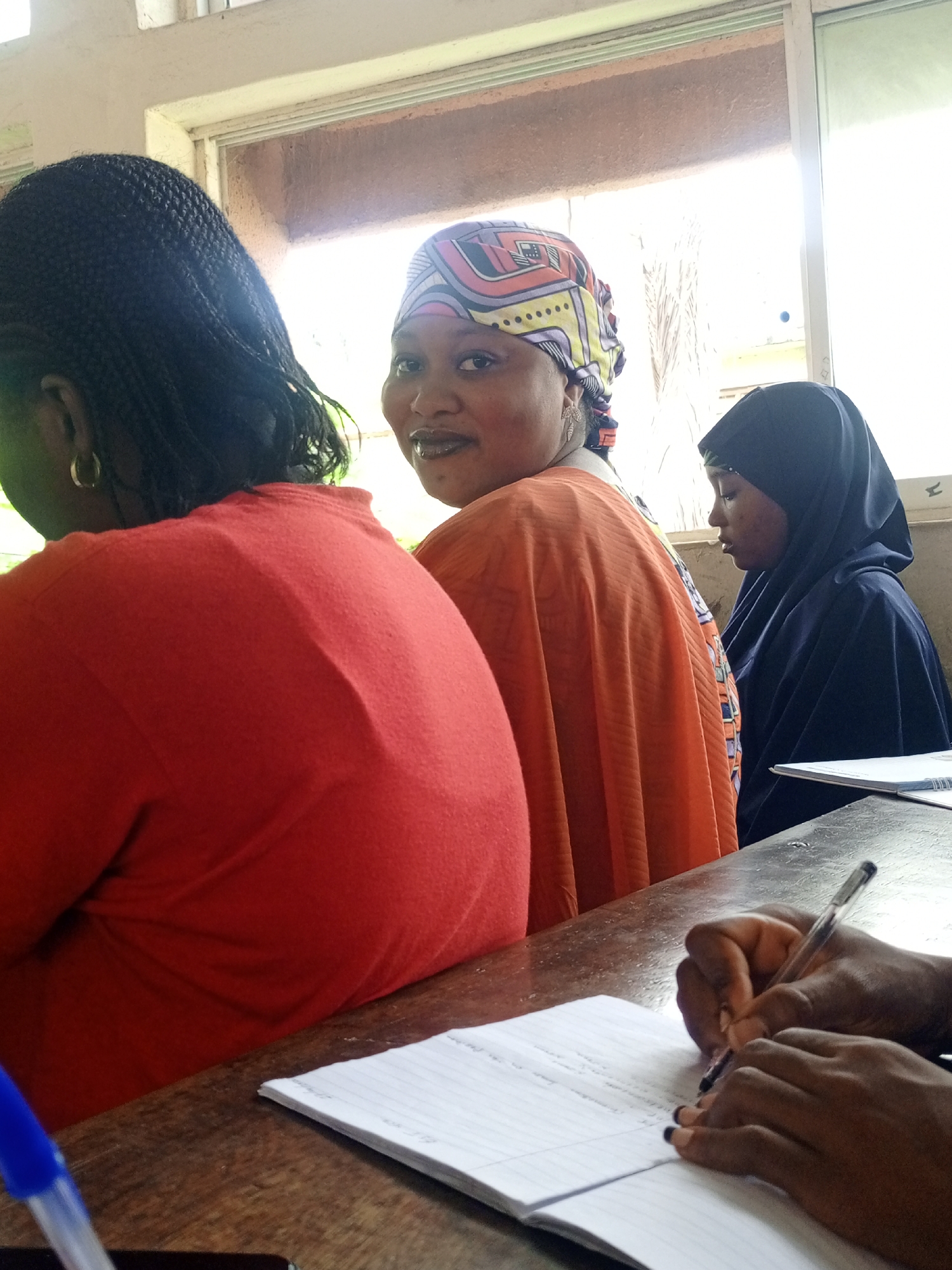Classroom lecture session with students taking notes documented
