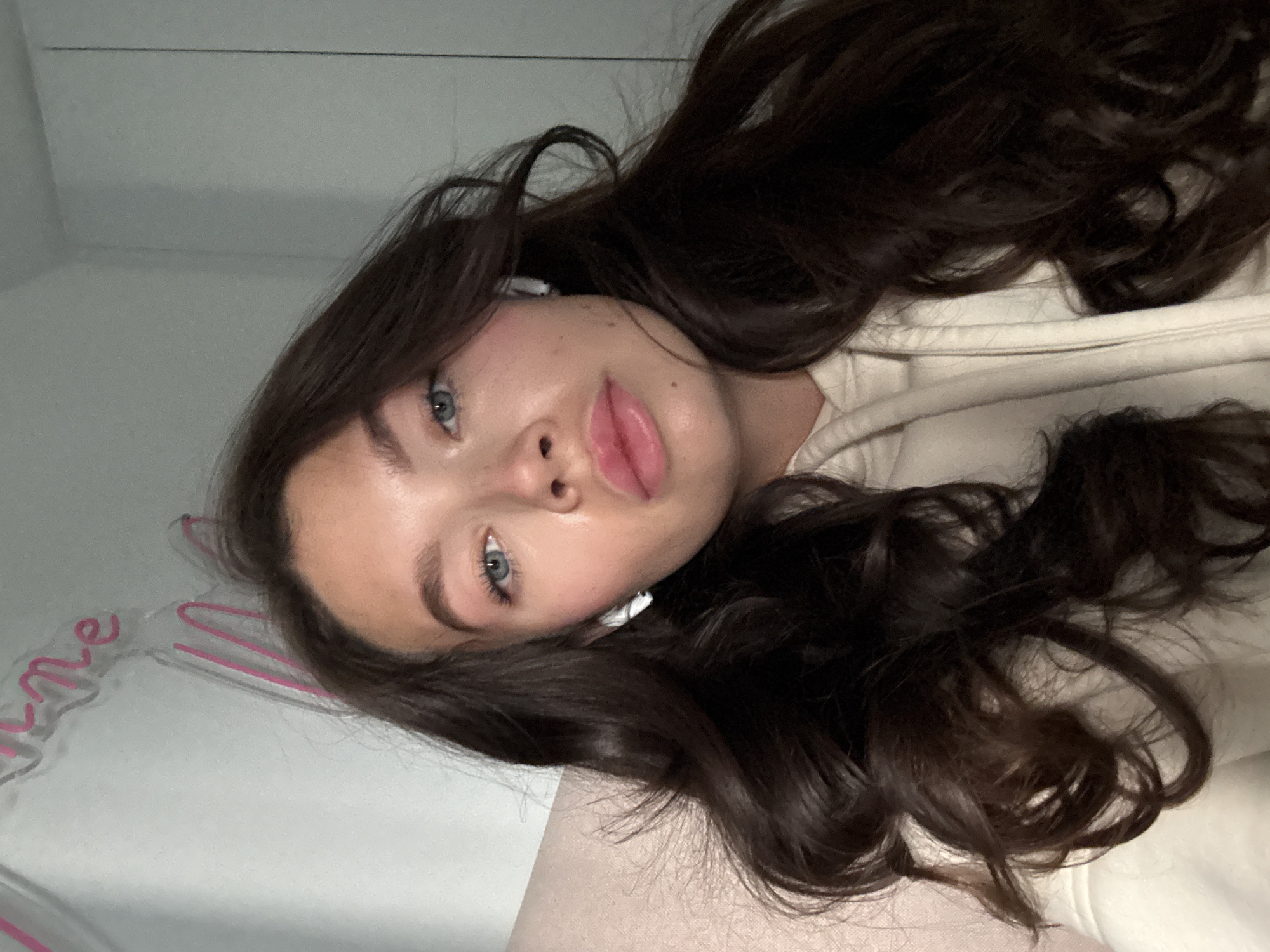 Woman takes selfies with pink device in Cyprus