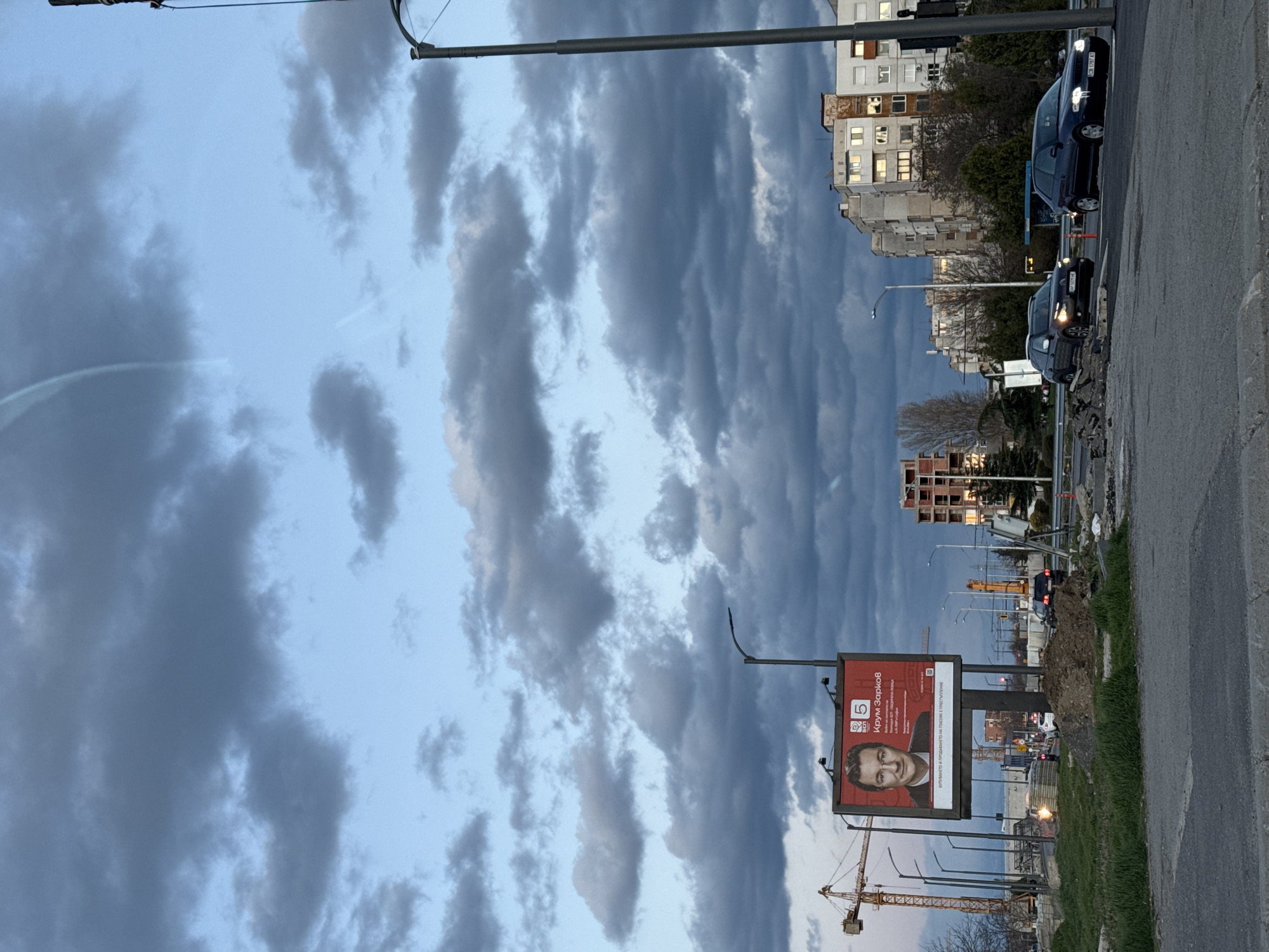 Traffic stops at red light in Sofia under stormy skies