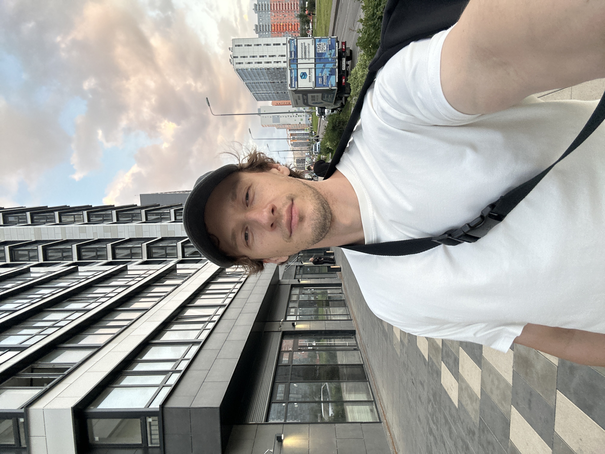 Sidewalk selfie in front of a modern building