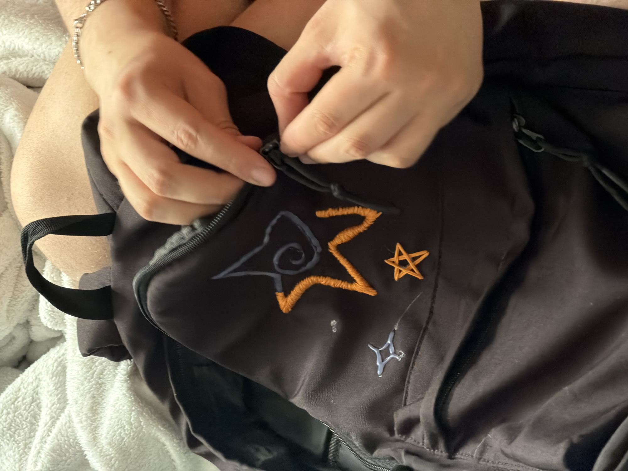 Person zips embroidered backpack in Perm, Russia