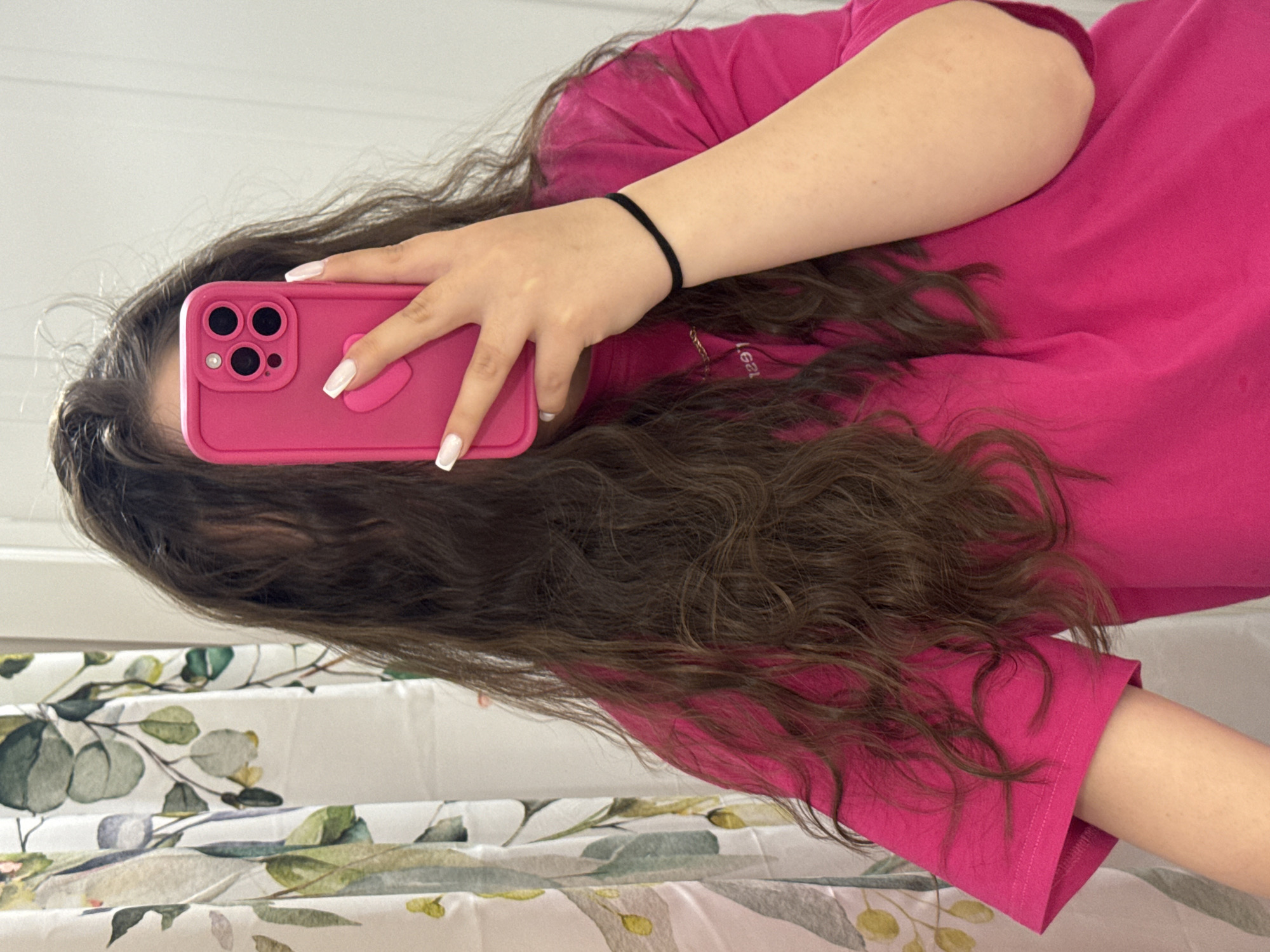 Person takes mirror selfies in pink shirt, Russia