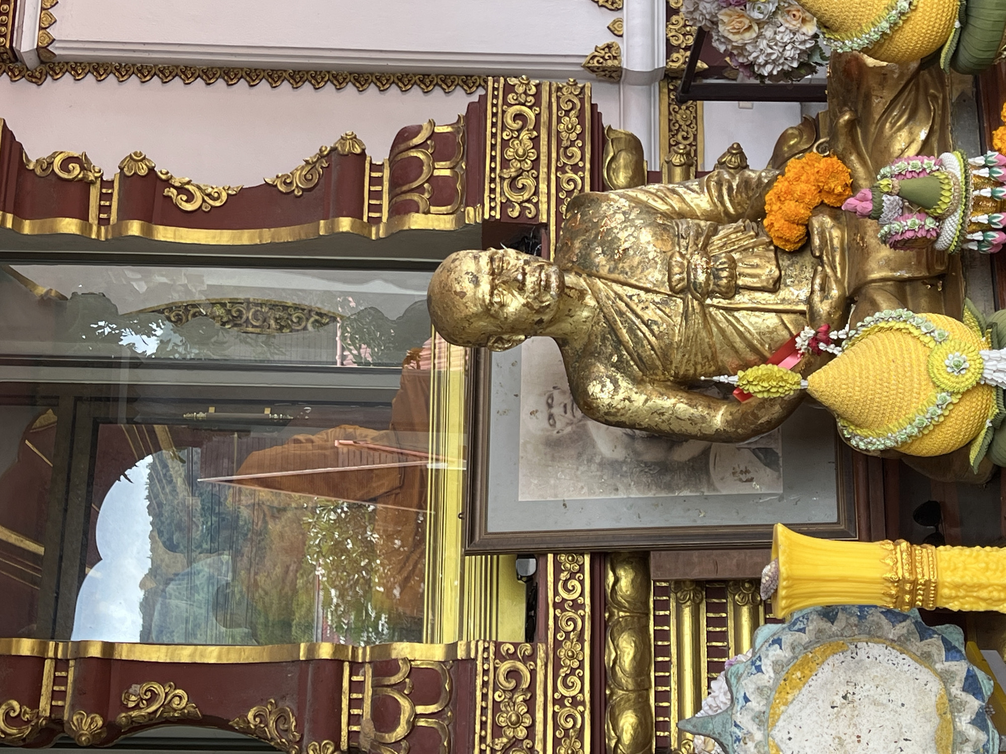 Mummified monk and golden shrines inside a Ko Samui temple