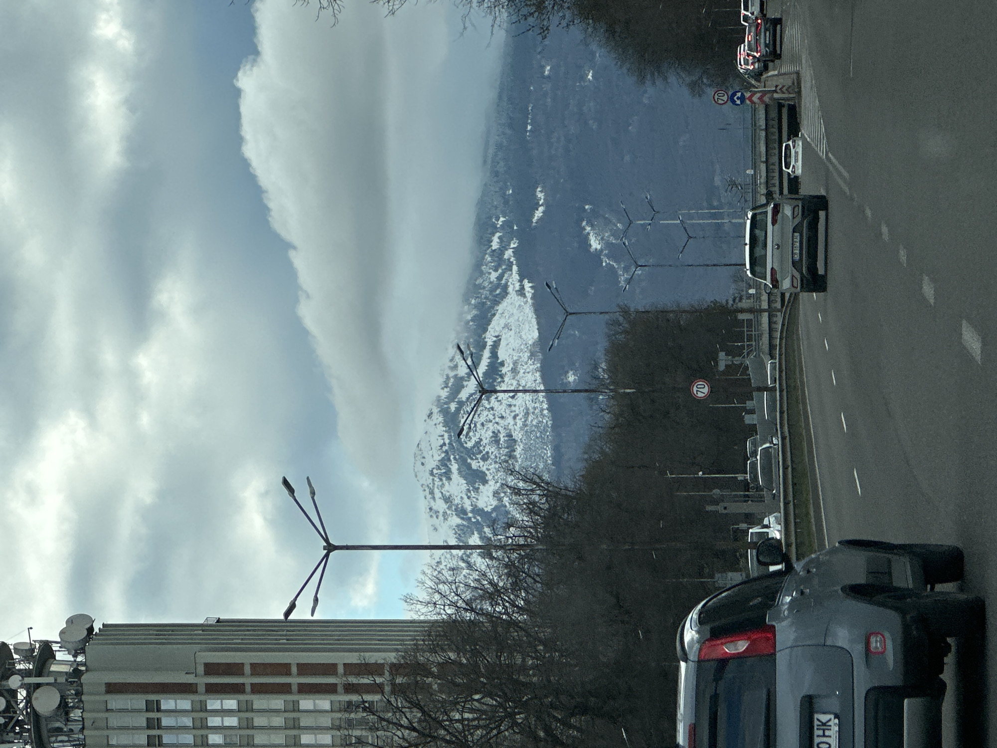 Sofia street view captures snow-capped mountains, antenna building