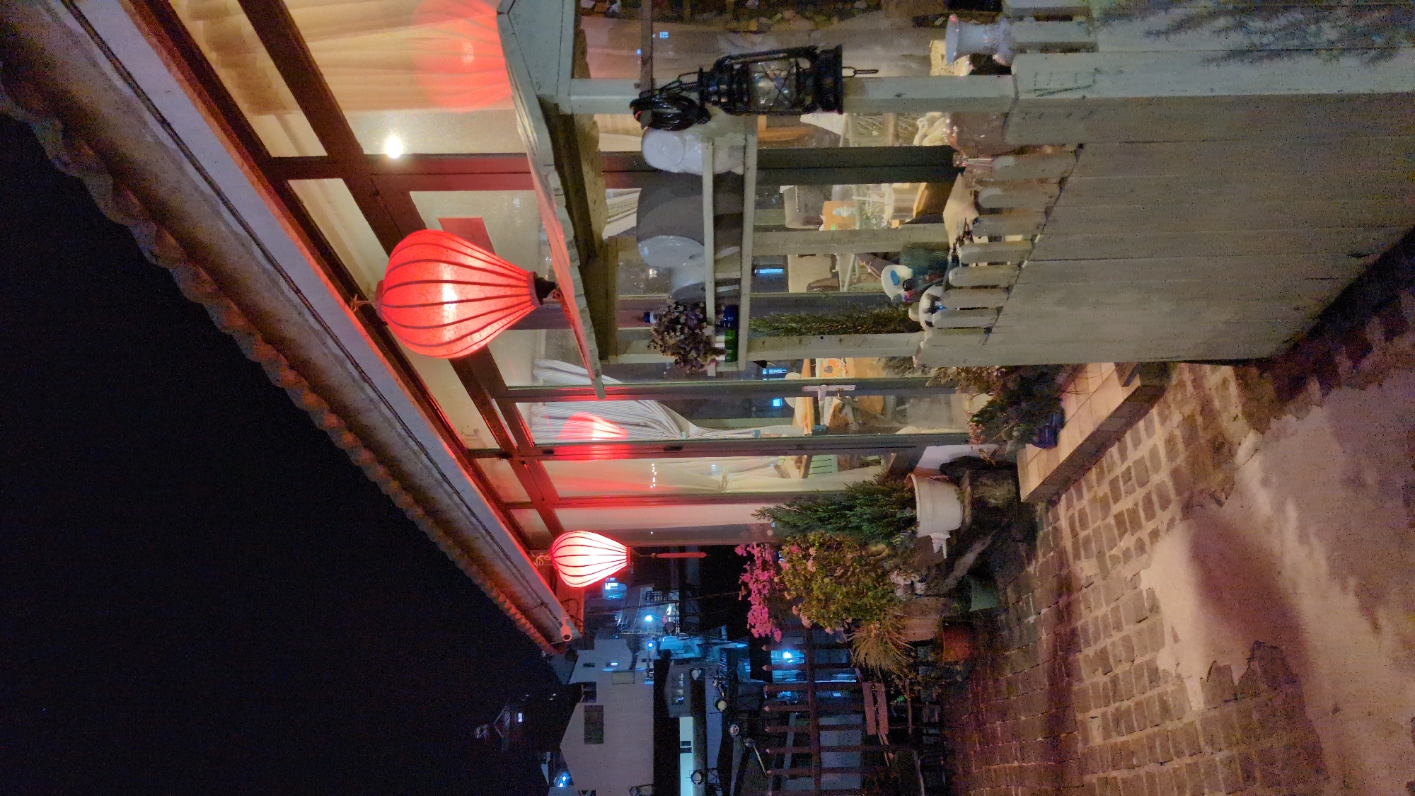 Red lanterns illuminate nighttime street scene in Da Lat