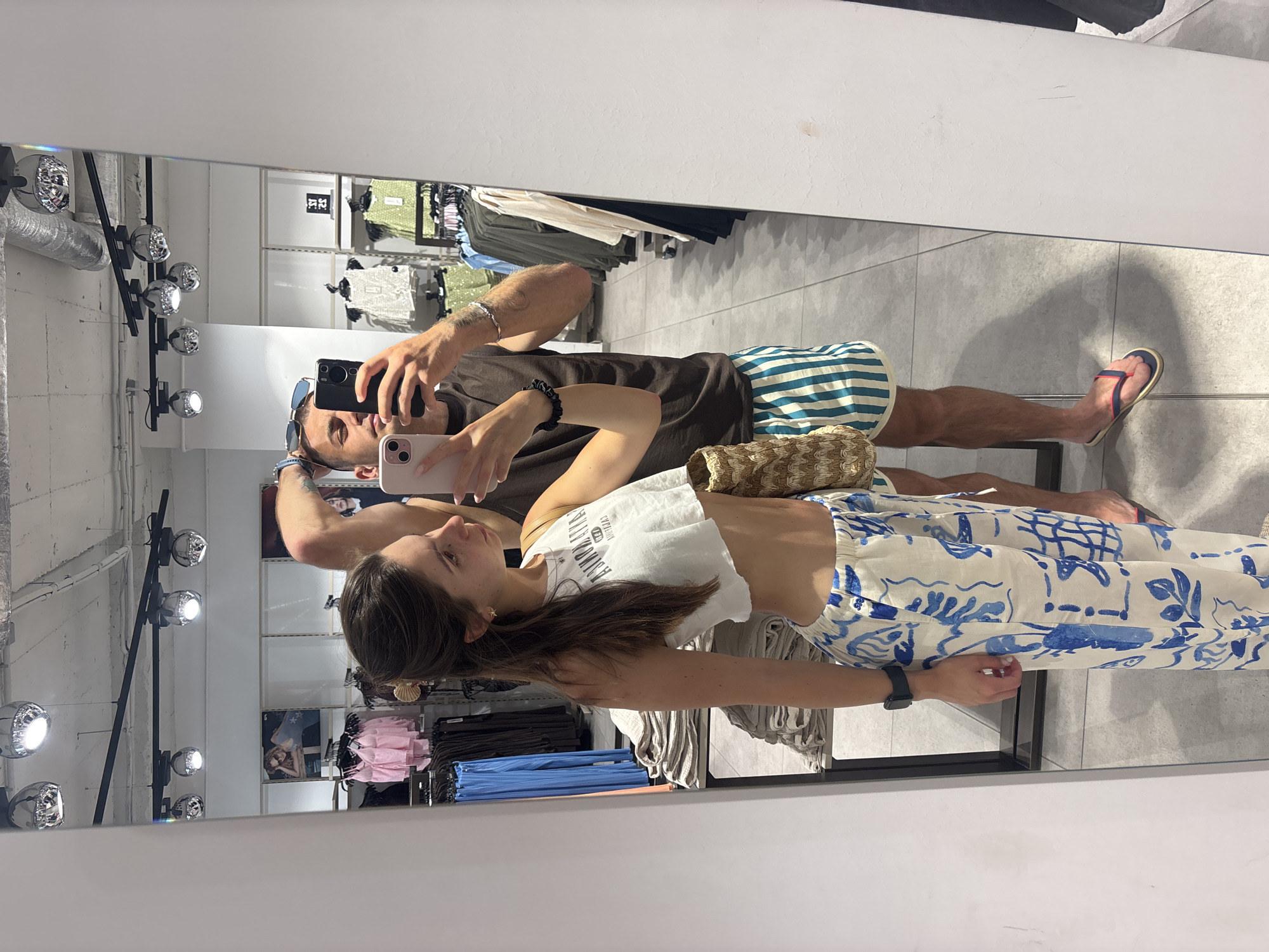 Mirror selfies in a Varna clothing store, summer 2026
