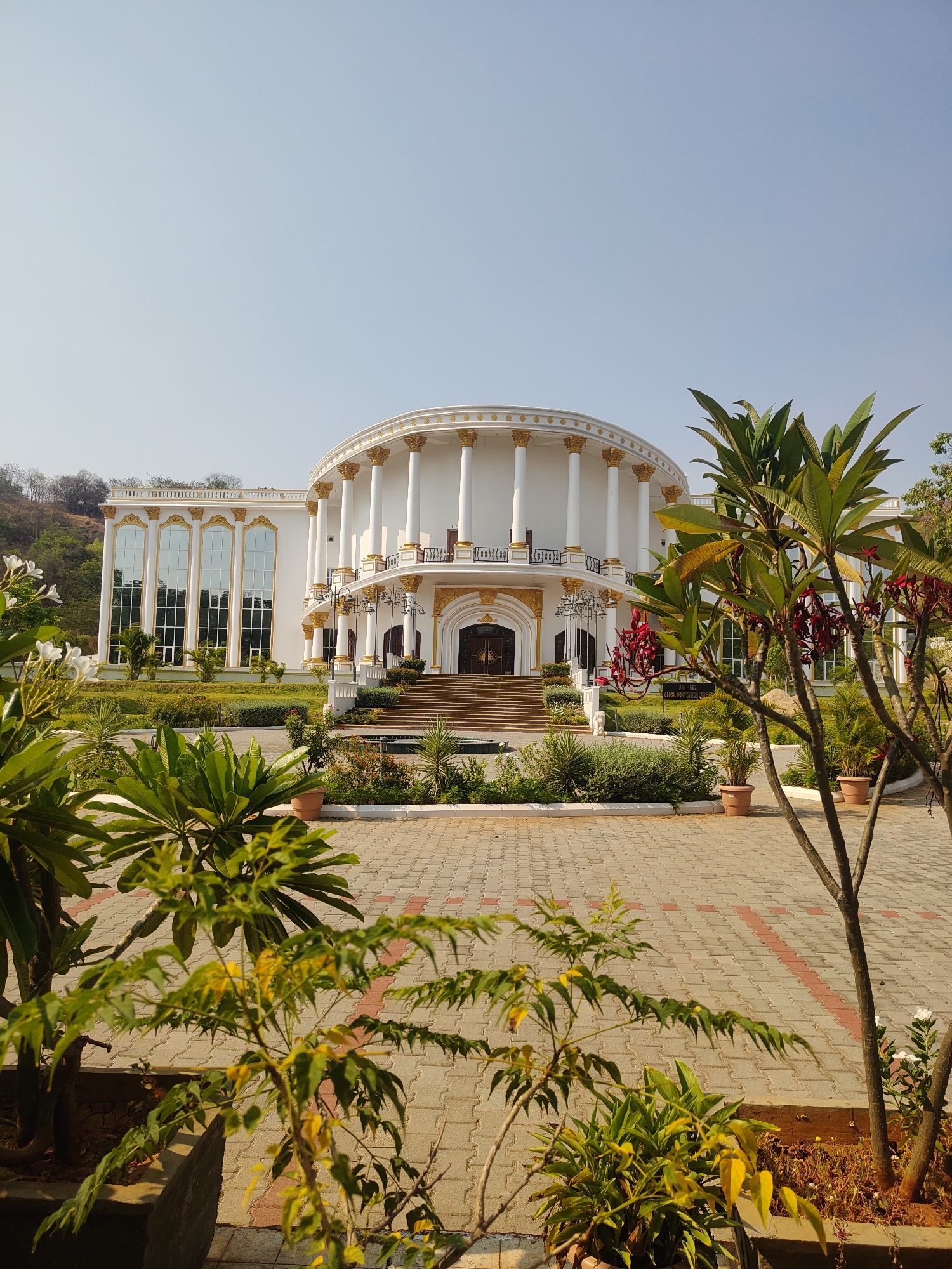 Classical white building with gold trim documented in Puttaparthi