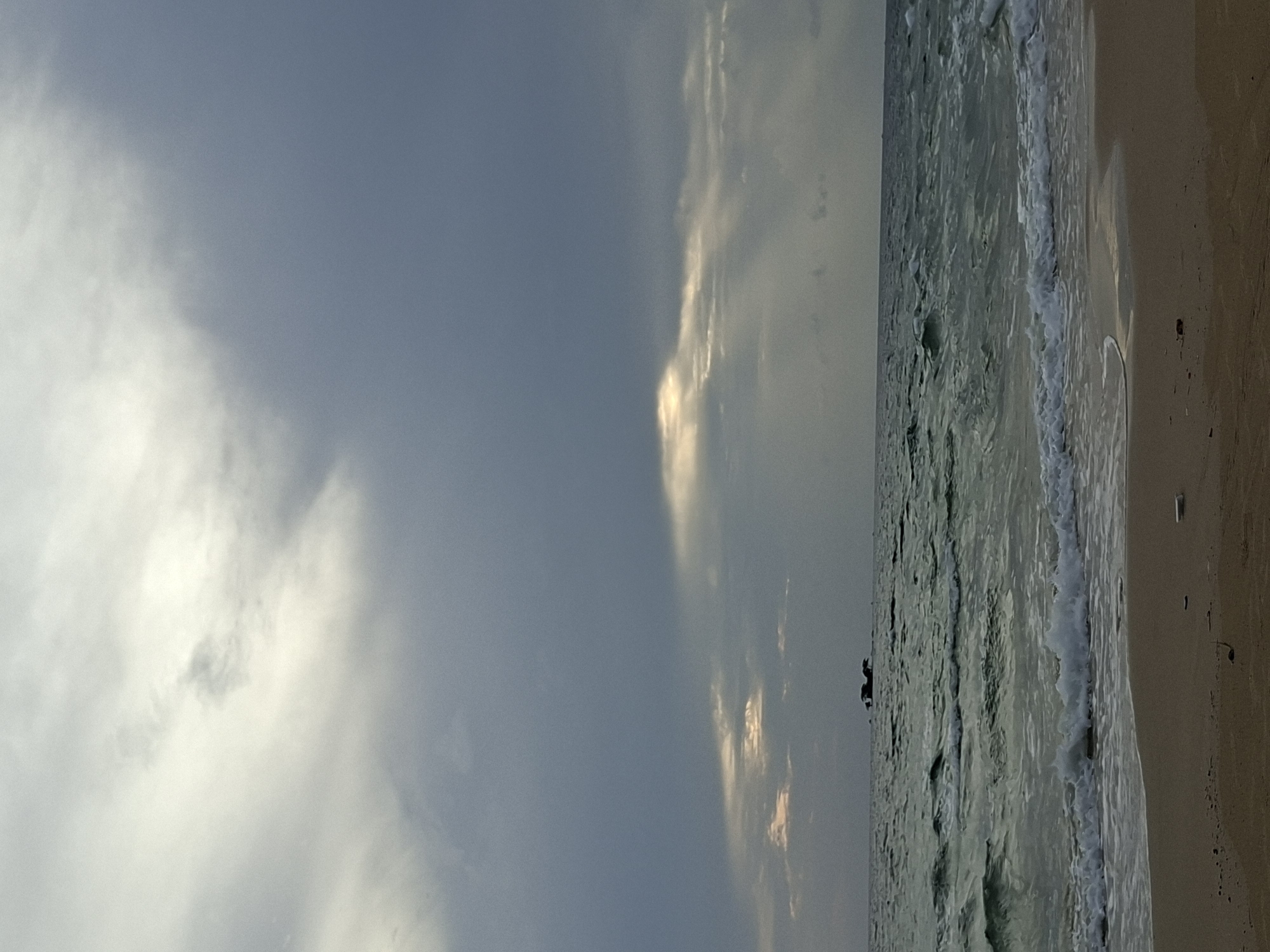 Phú Quốc shoreline under a brooding, cloud-streaked sky