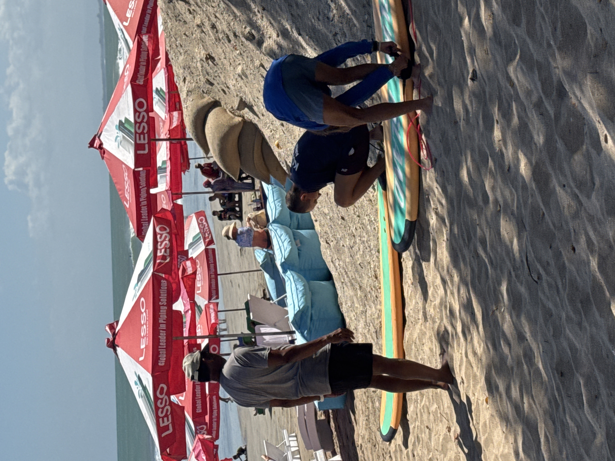 Kuta Beach morning: surfboards, snack vendors, and shoreside chairs