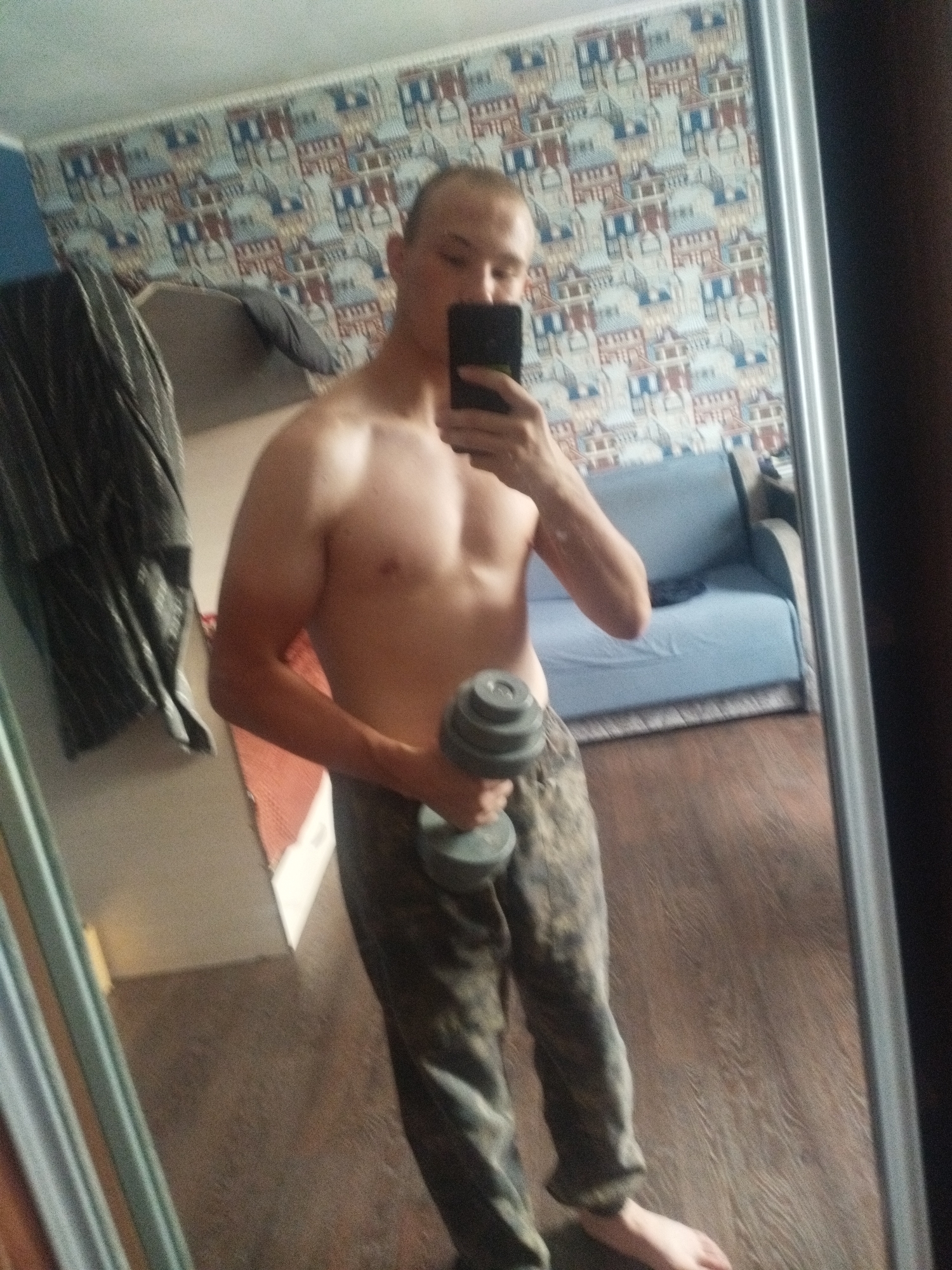 Mirror selfie with dumbbell in a Kirensk apartment
